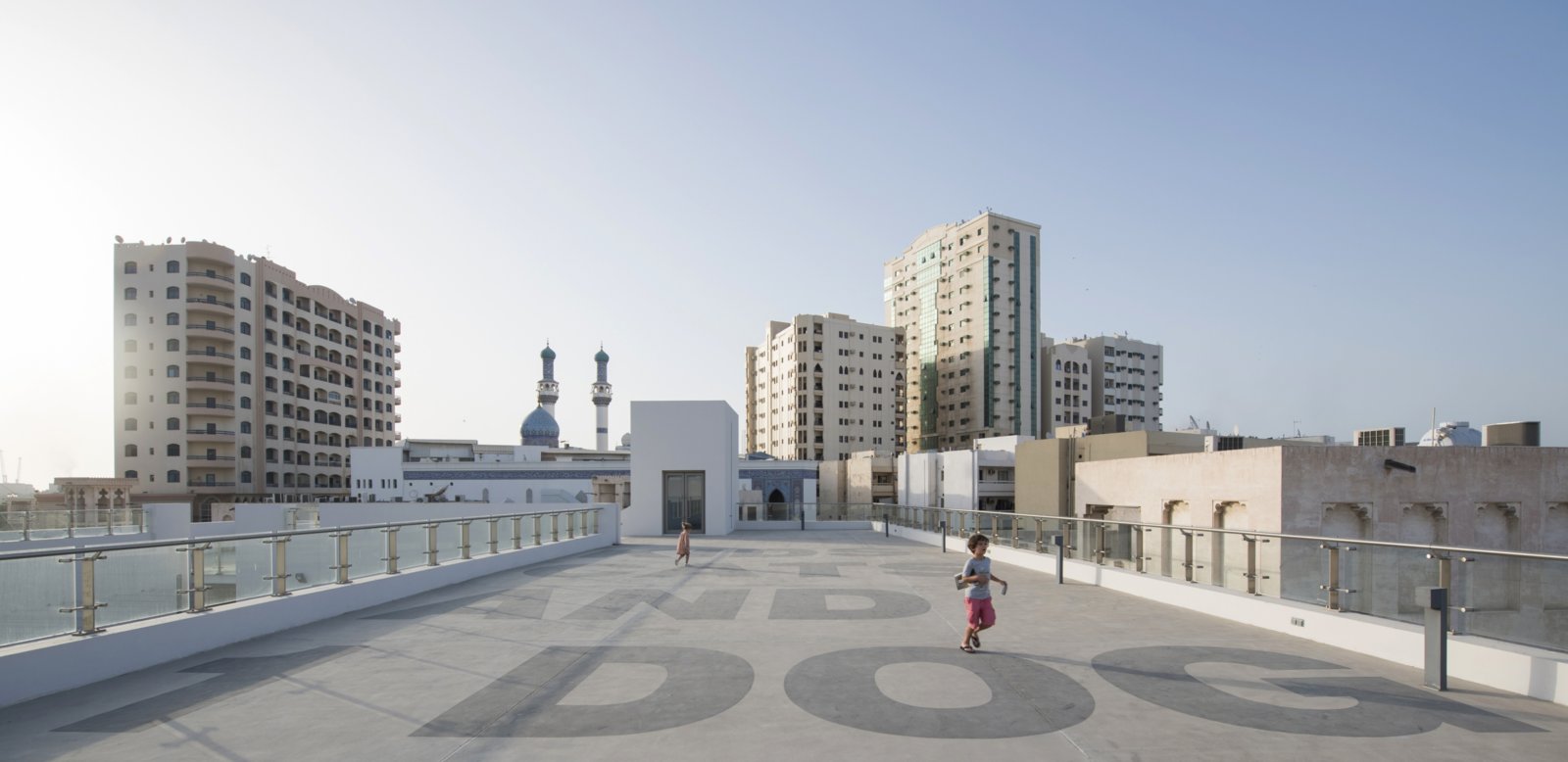 Abbas Akhavan, Kids, Cats and 1 Dog, 2016, paint on rooftop, 591 x 394 in. (1500 x 1000 cm). Installation view, Sharjah Biennial 13, Al Mureijah Square, Sharjah, UAE, 2017