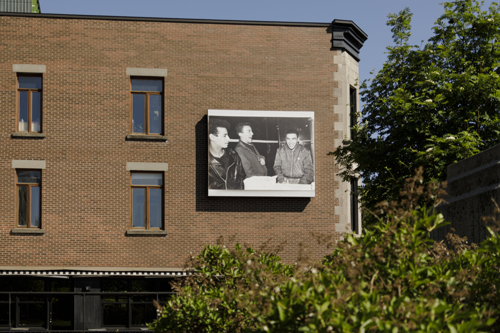 Abbas Akhavan, Omay, Djamal, Albert. hiver 1982, 2023, digital inkjet print on billboard. Installation view, Café Cherrier, Dazibao Satellite, Montreal, Canada, 2023