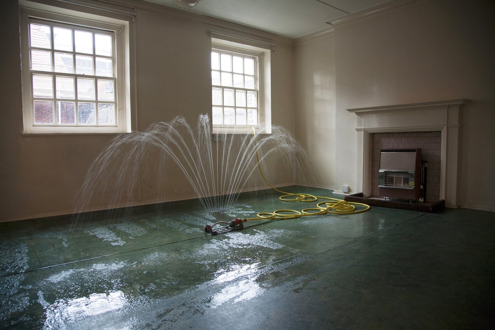 Abbas Akhavan, Study for a Garden: Fountain, 2012, oscillating water sprinkler, pump, hose, pvc pond liner, water, dimensions variable. Installation view, Study for a Garden, Delfina Foundation, London, UK, 2012