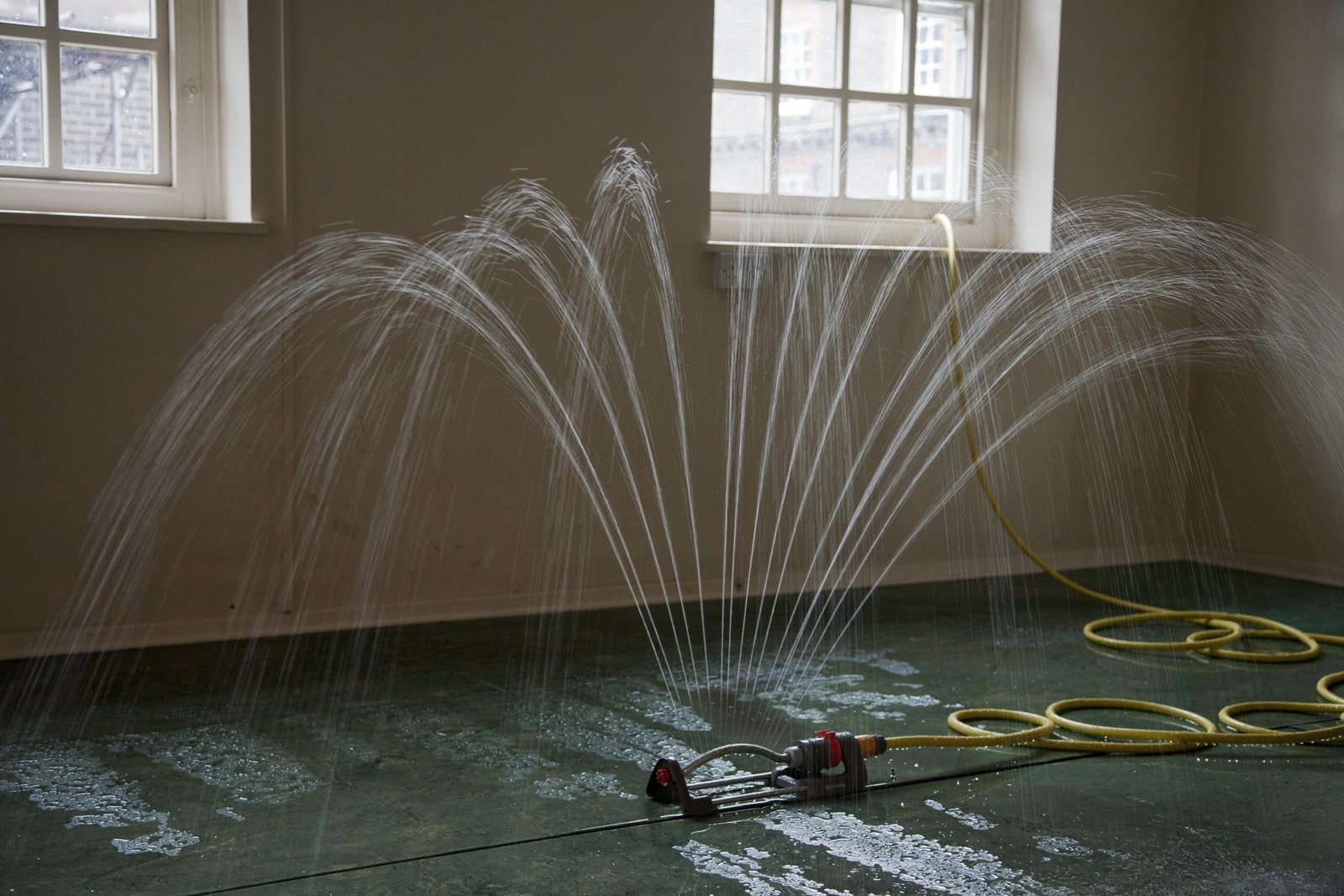 Abbas Akhavan, Study for a Garden: Fountain, 2012, oscillating water sprinkler, pump, hose, pvc pond liner, water, dimensions variable. Installation view, Study for a Garden, Delfina Foundation, London, UK, 2012