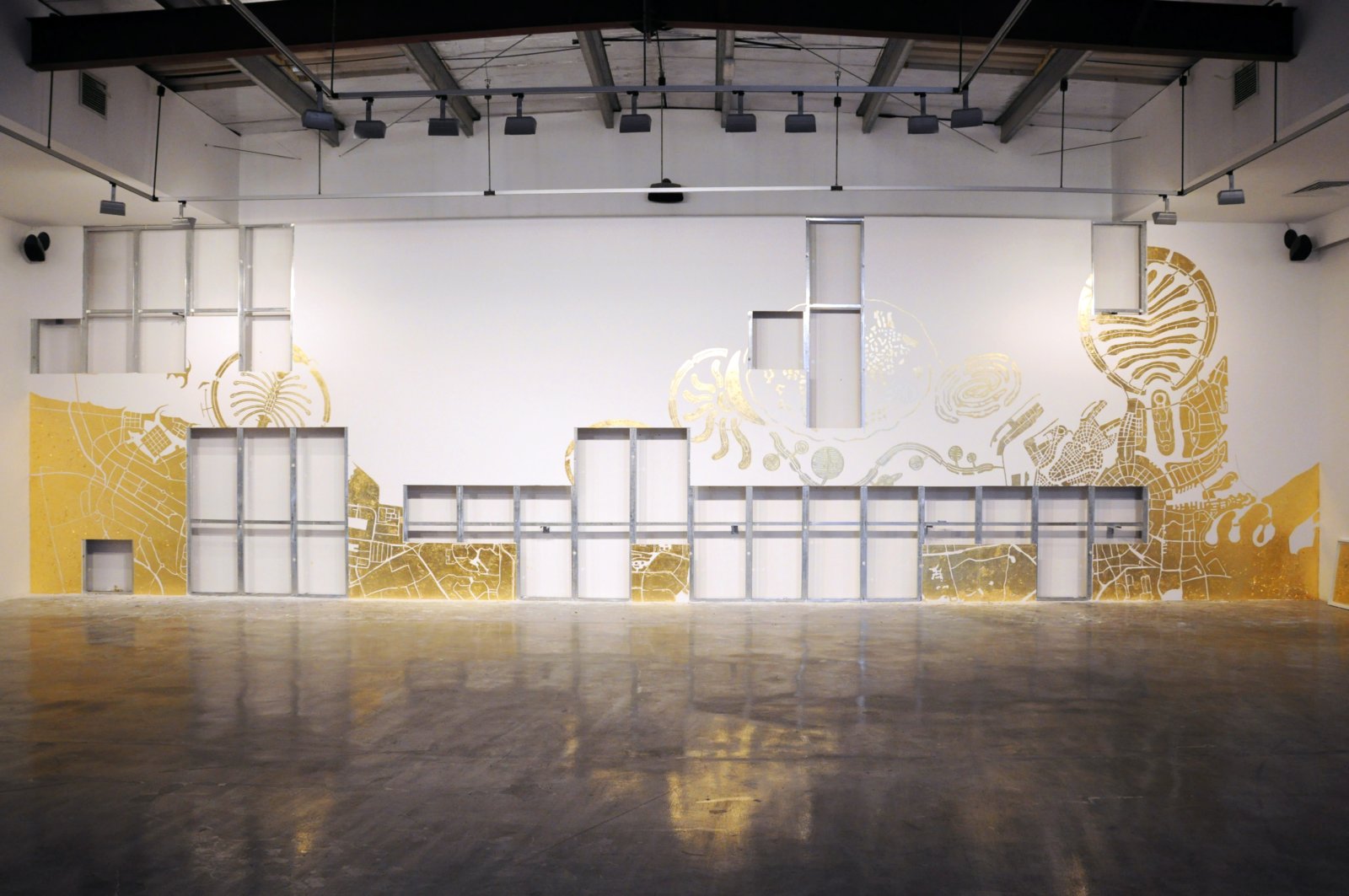 Abbas Akhavan, Study for a Map, 2010, imitation gold leaf on gallery wall, 157 x 551 in. (400 x 1400 cm). Installation view, Islands, The Third Line, Dubai, UAE, 2010