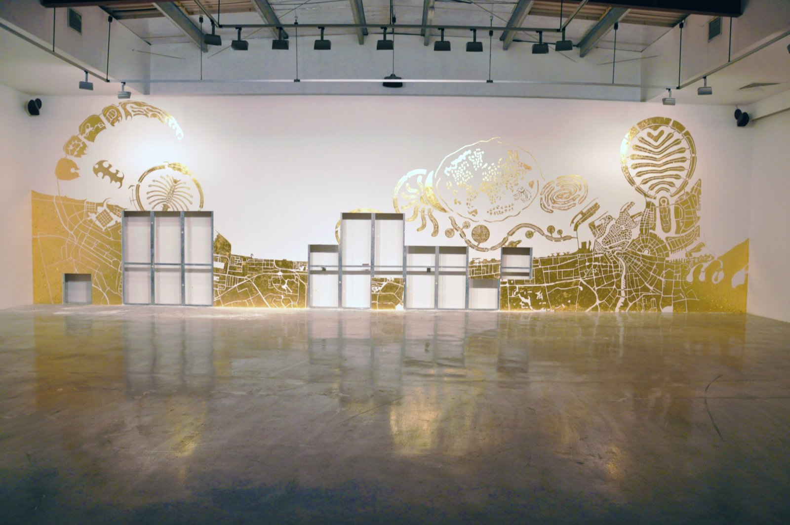 Abbas Akhavan, Study for a Map, 2010, imitation gold leaf on gallery wall, 157 x 551 in. (400 x 1400 cm). Installation view, Islands, The Third Line, Dubai, UAE, 2010