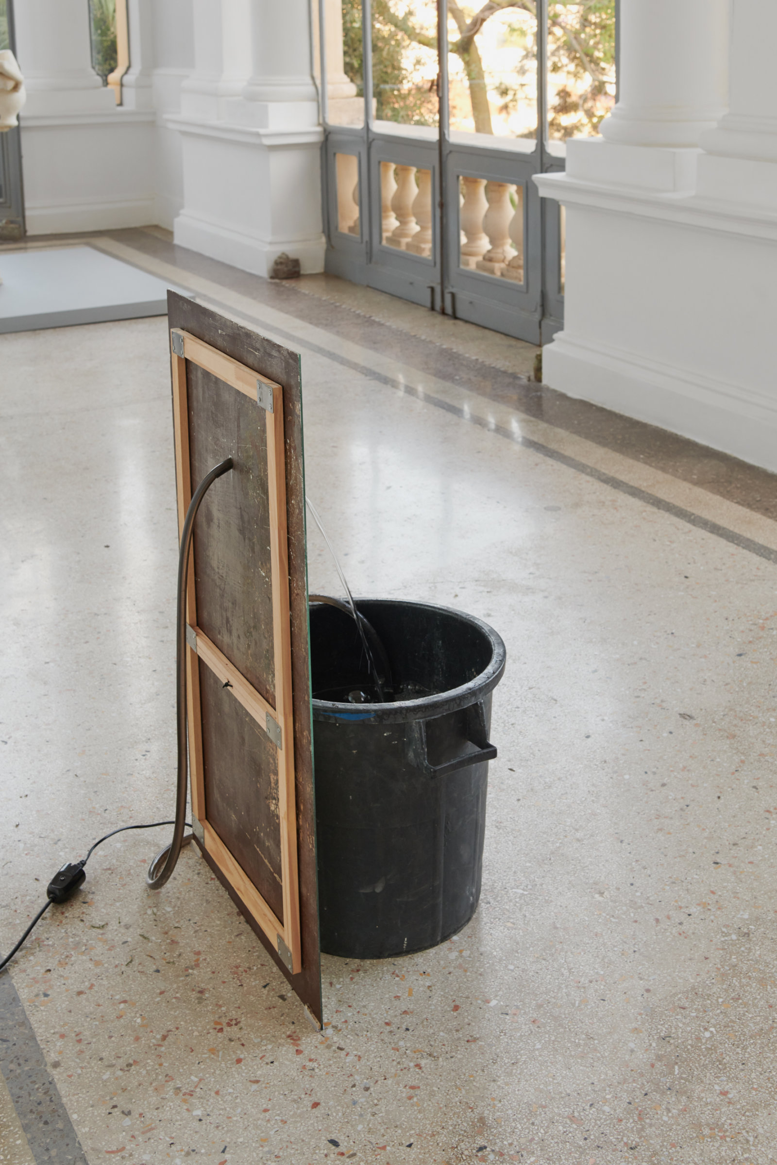 Abbas Akhavan, fountain, 2022, plastic bin, mirror, pond pump, tubing, water, snail mucin serum, Glantamine, 41 x 24 x 19 in. (105 x 60 x 48 cm). Installation view, Mettere al mondo il mondo, Thomas Dane Gallery, Naples, Italy, 2022