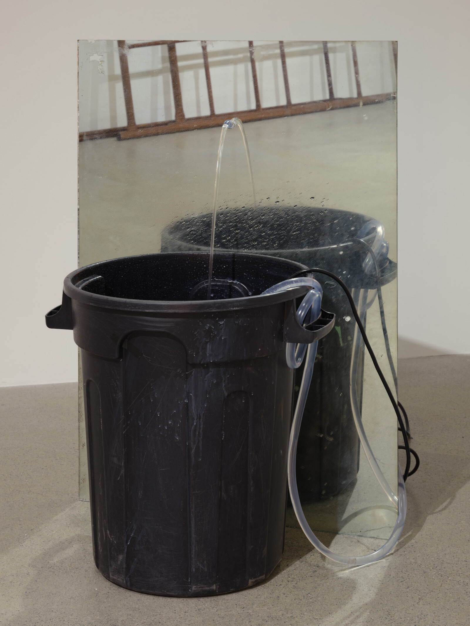 Abbas Akhavan, fountain, 2022, plastic bin, mirror, pond pump, tubing, water, snail mucin serum, Galantamine, 42 x 28 x 20 in. (107 x 71 x 51 cm)