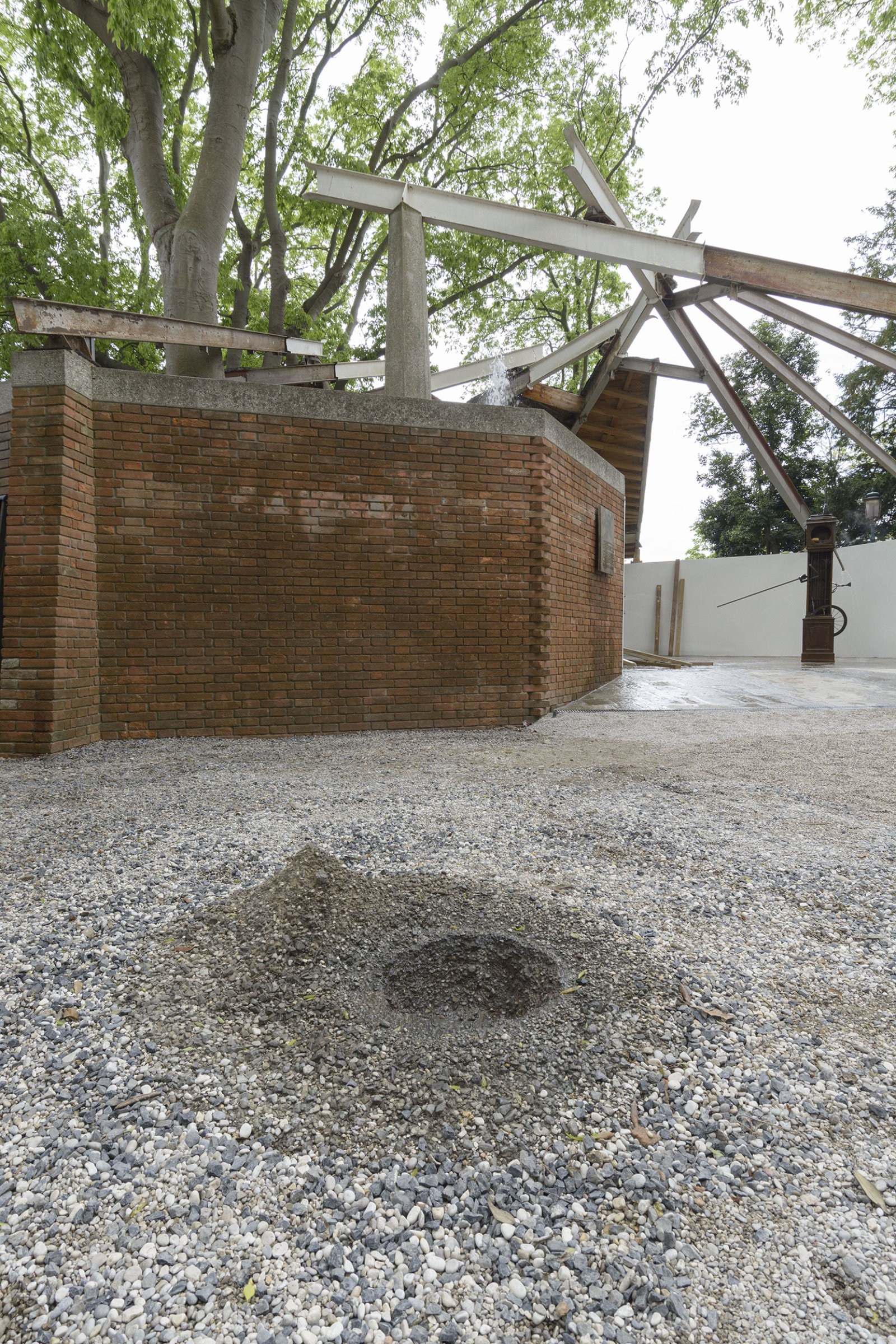 Geoffrey Farmer, Drinking Fountain, 2017, tombak cast of a hole in the ground, sensor, water technics, 12 x 63 x 55 in. (30 x 160 x 140 cm). Installation view, A way out of the mirror, Canada Pavilion, 57th Venice Biennale, Venice, Italy
