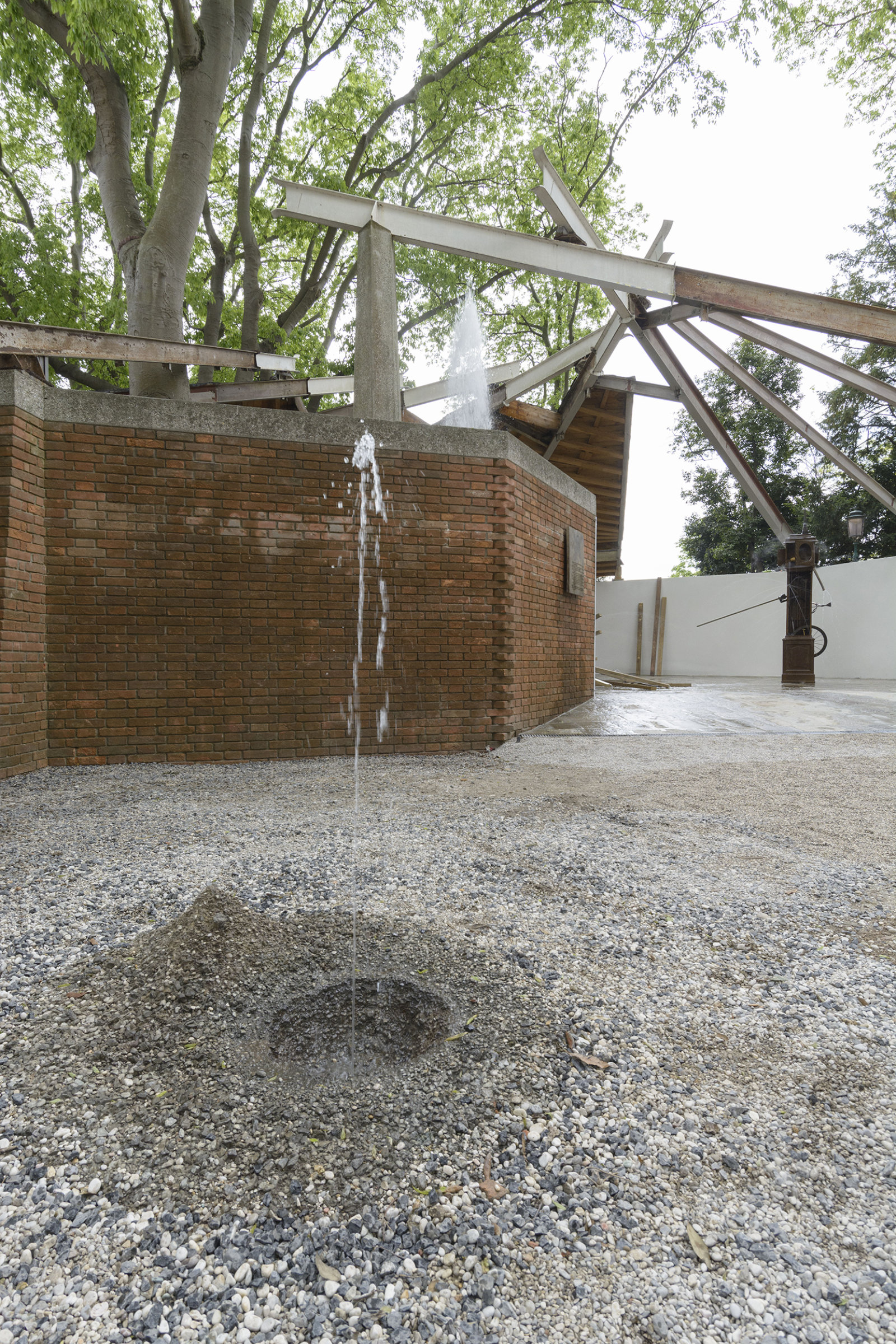 Geoffrey Farmer, Drinking Fountain, 2017, tombak cast of a hole in the ground, sensor, water technics, 12 x 63 x 55 in. (30 x 160 x 140 cm). Installation view, A way out of the mirror, Canada Pavilion, 57th Venice Biennale, Venice, Italy