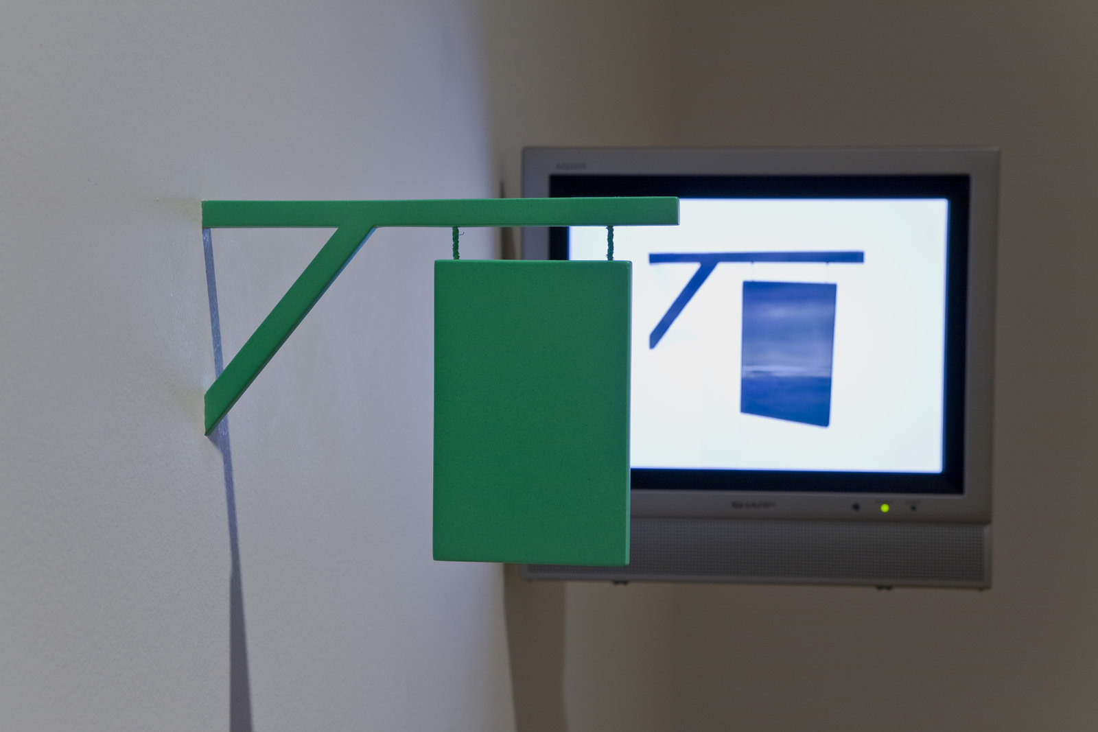 Geoffrey Farmer, I thought that I could make a machine that would pierce the fabric of reality, in your world it appears as a 16th-century sign, 2004, DVD , monitor, sculpture dimensions variable