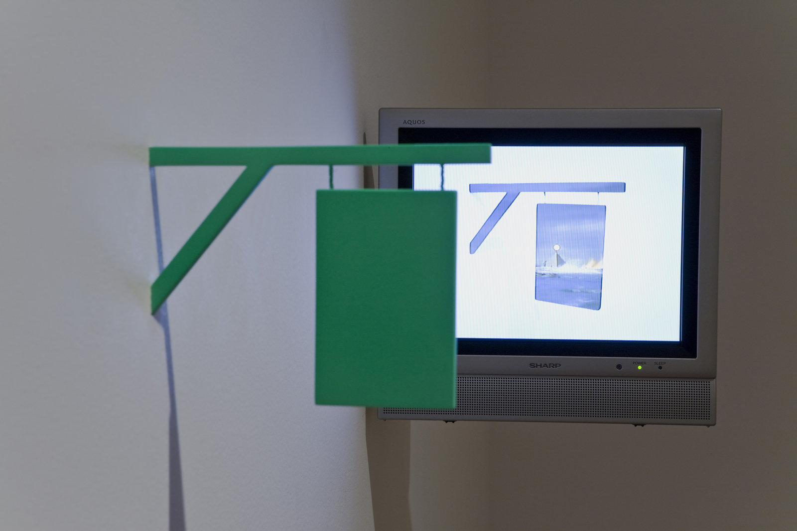 Geoffrey Farmer, I thought that I could make a machine that would pierce the fabric of reality, in your world it appears as a 16th-century sign, 2004, DVD , monitor, sculpture dimensions variable