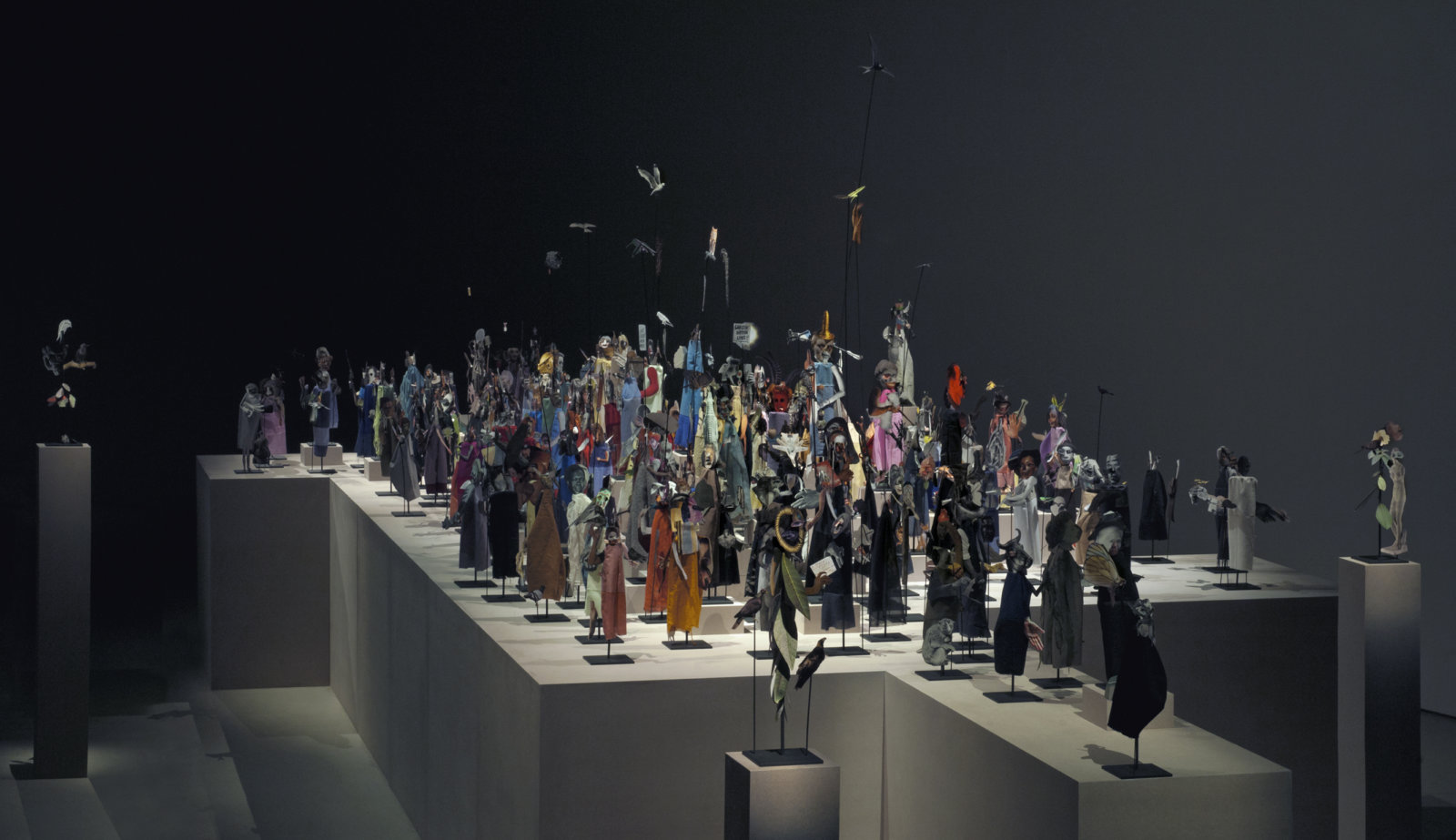 Geoffrey Farmer, The Surgeon and the Photographer, 2009, paper, textile, wood, and metal, 365 figures, dimensions variable. Installation view, Barbican Centre, London, 2013