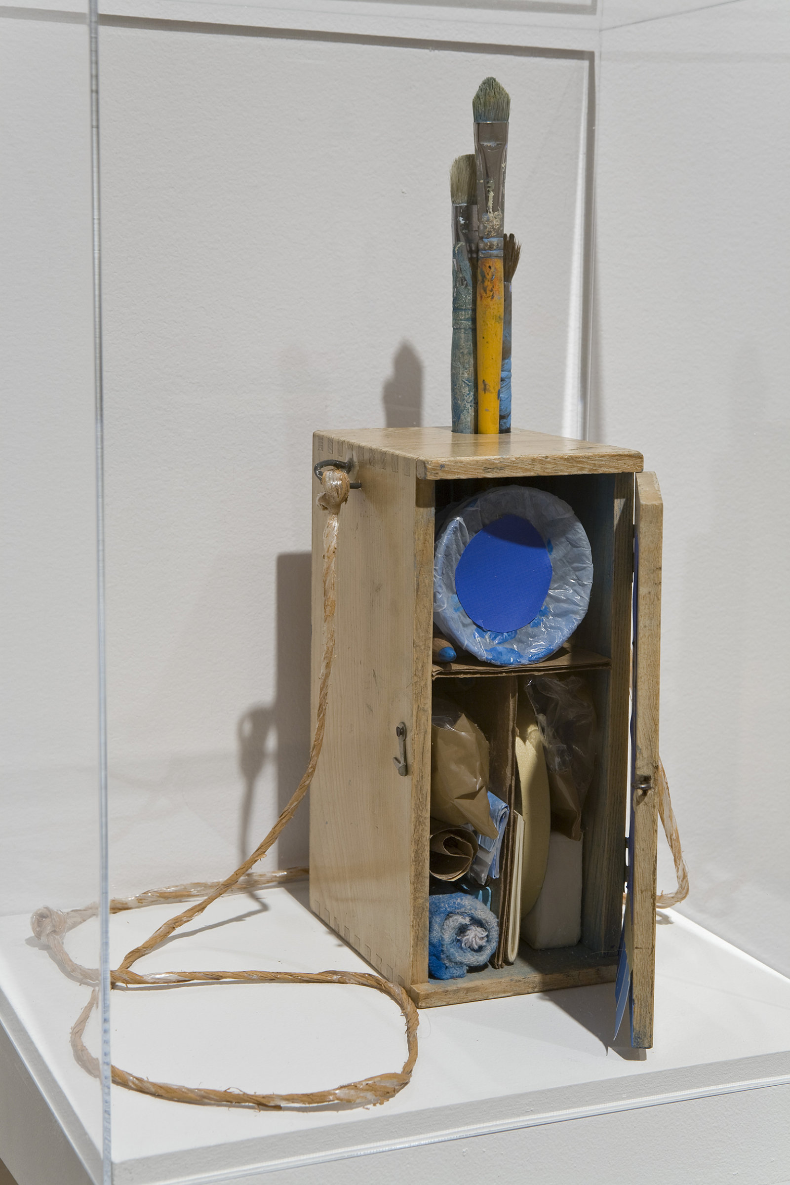 Geoffrey Farmer, Void Numbering Project (continuous), 1992, wooden box containing various materials such as paint, paintbrushes, masking tape and shelf with plexiglass top, dimensions variable