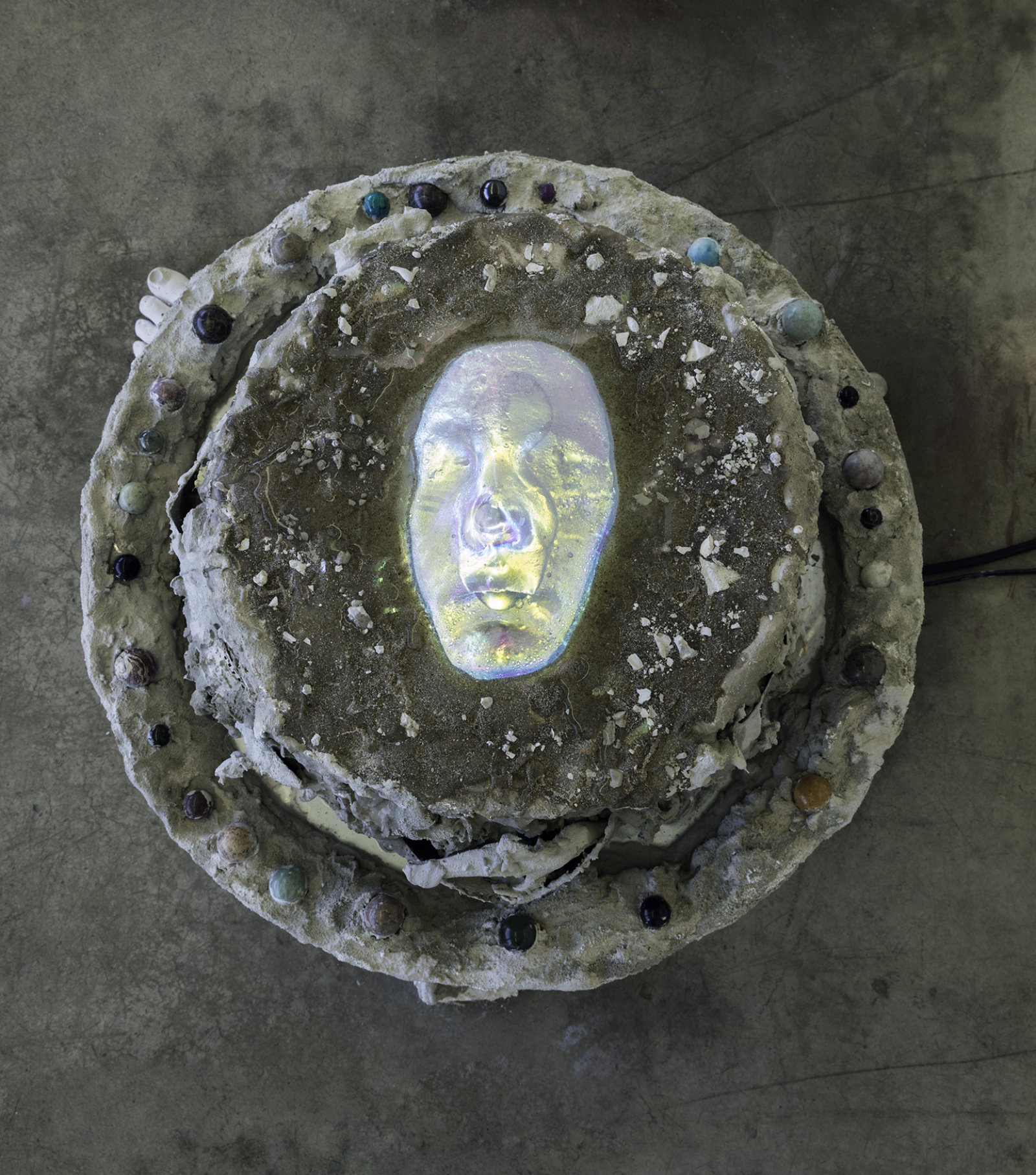 Kasper Feyrer, “I” (detail), 2017, dichroic glass face, concrete, miscellaneous aggregate, mineral marbles, water, 25 x 25 x 21 in. (62 x 62 x 53 cm)