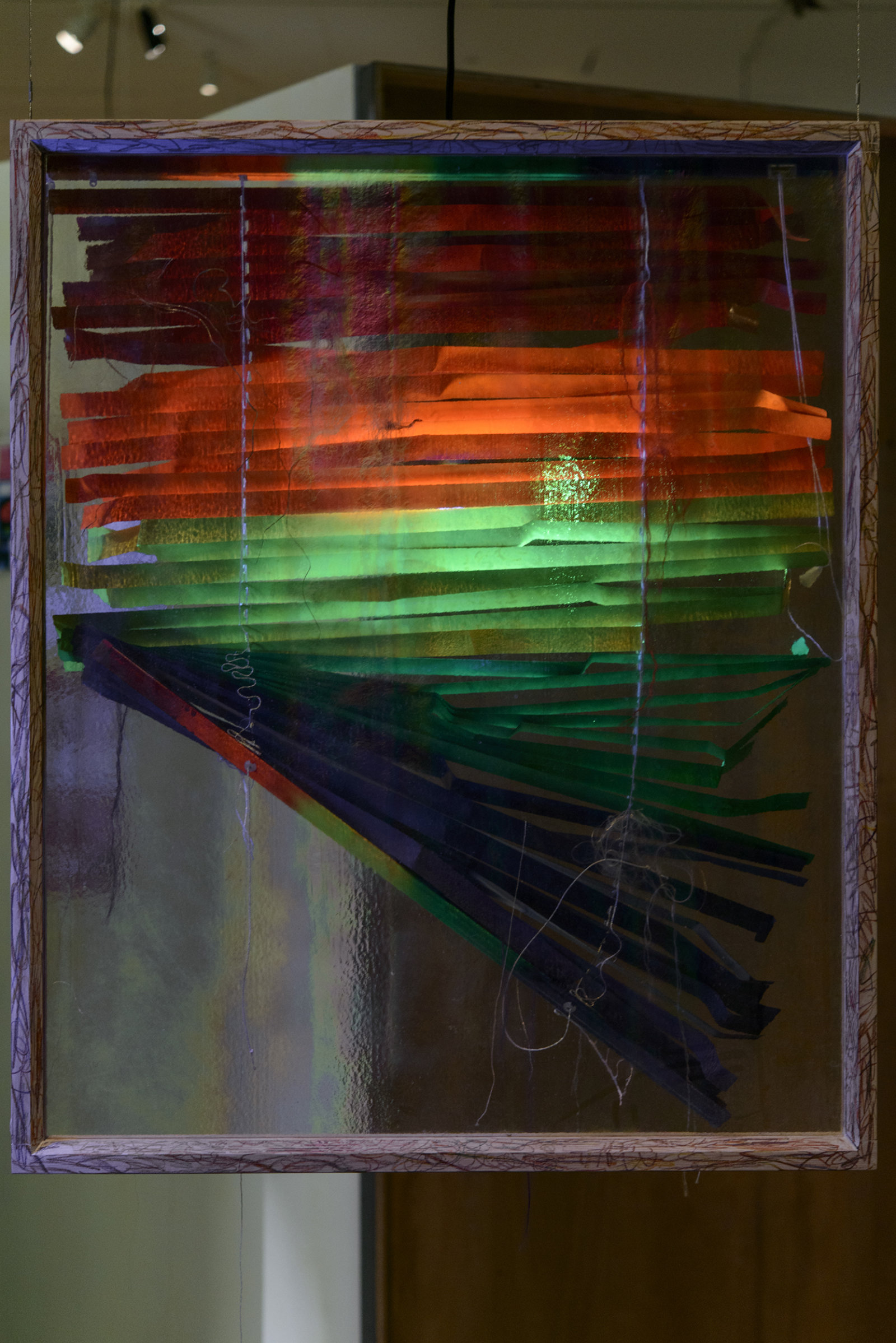 Kasper Feyrer, Blinded/Braided, 2013, venetian blind, human hair, corn hair, wig hair, milk wash wood frame with rainbow crayon, dimensions variable. Installation view, The Intellection of Lady Spider House, Art Gallery of Alberta, 2013.