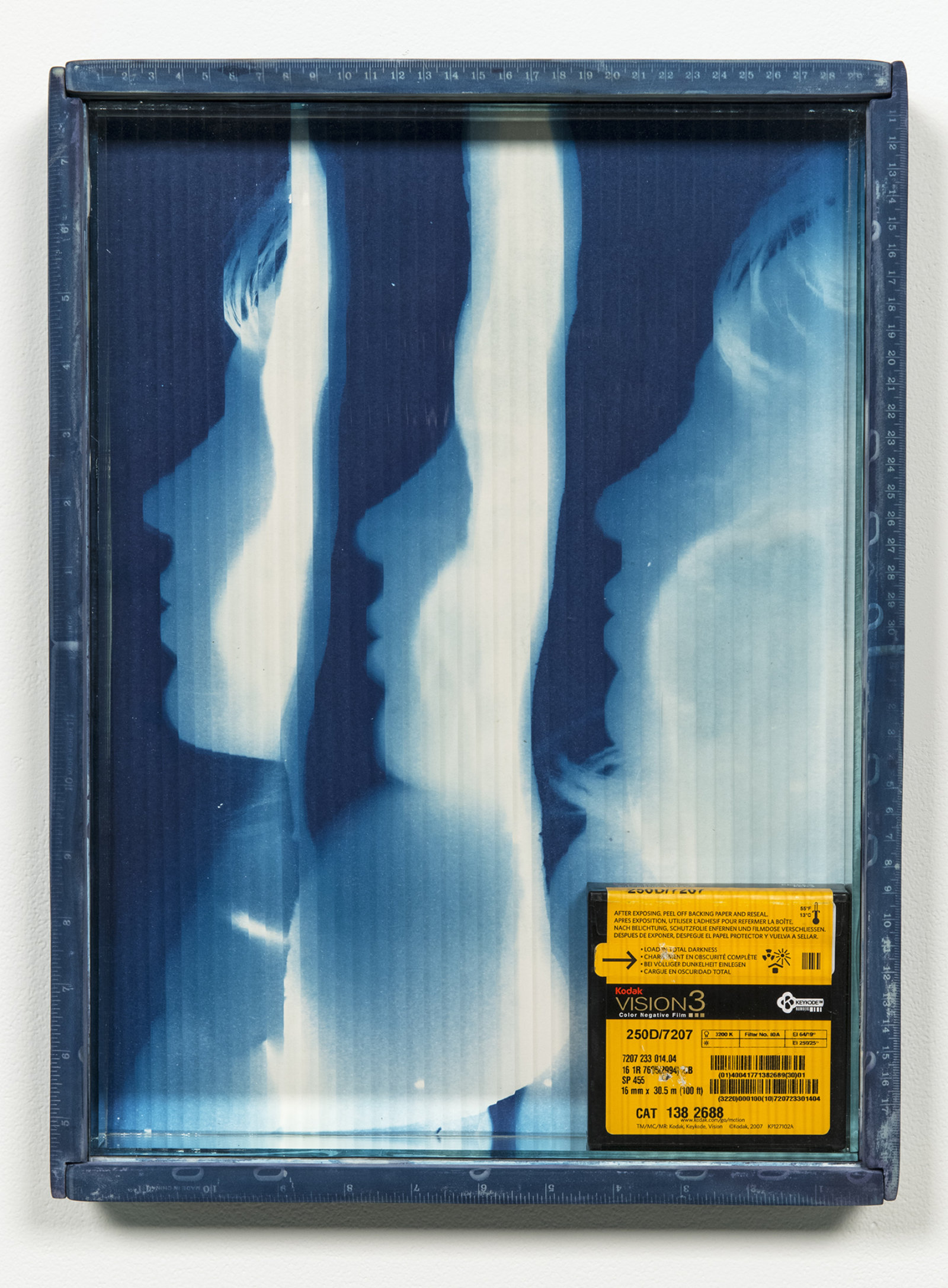 Kasper Feyrer, Vision3, 2012, cyanotype treated pine wood frame, cyanotype on watercolour paper, mirror inset, quarter reed architectural glass, 16mm vision3 kodak 100ft film canister, 17 x 13 in. (43 x 32 cm)