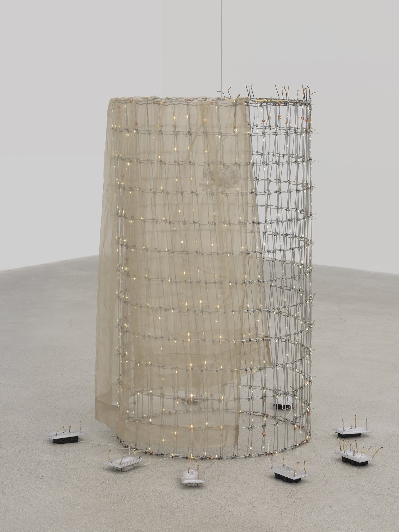 ​Rochelle Goldberg, Trigger: Towards everything they’ve ever wanted, 2019, ranch fencing, batteries, fairy lights, polyester curtain, aluminum, cast bronze matches, copper wire, 51 x 51 x 44 in. (130 x 130 x 112 cm) by Rochelle Goldberg