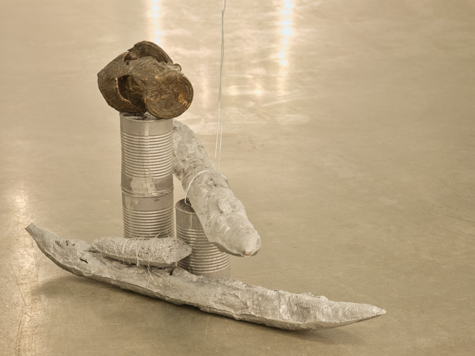 Rochelle Goldberg, Obstructed View, 2023, patinated bronze, raw cast bronze, 9 aluminum baguettes, 77 baguettes with silver dispersion paint, aluminum cans, copper pennies, steel cable, aluminum wire, 3 vanity lights, dimensions variable. Installation view, Sun Moon Stars, Contemporary Art Gallery, Vancouver, 2024