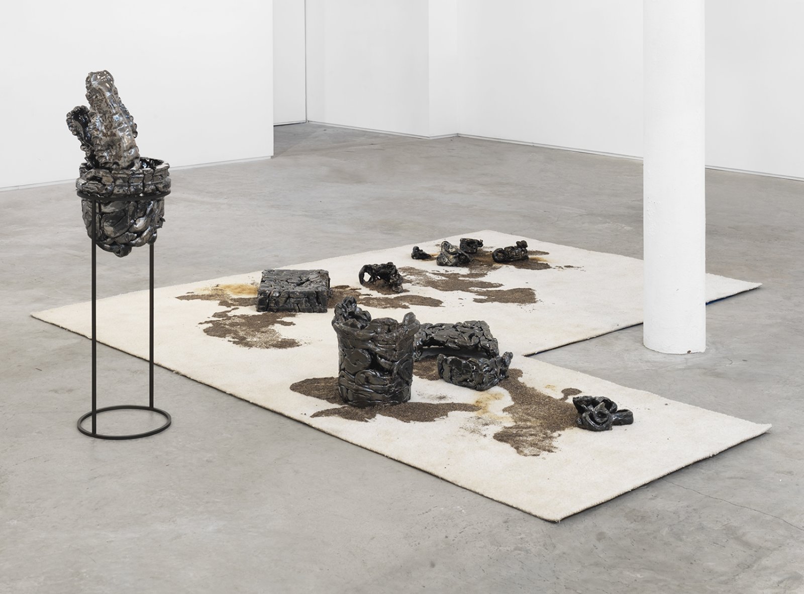 Rochelle Goldberg, The element of stain, 2015, metallic glazed ceramic elements, carpet, chia seeds, crude oil, dimensions variable