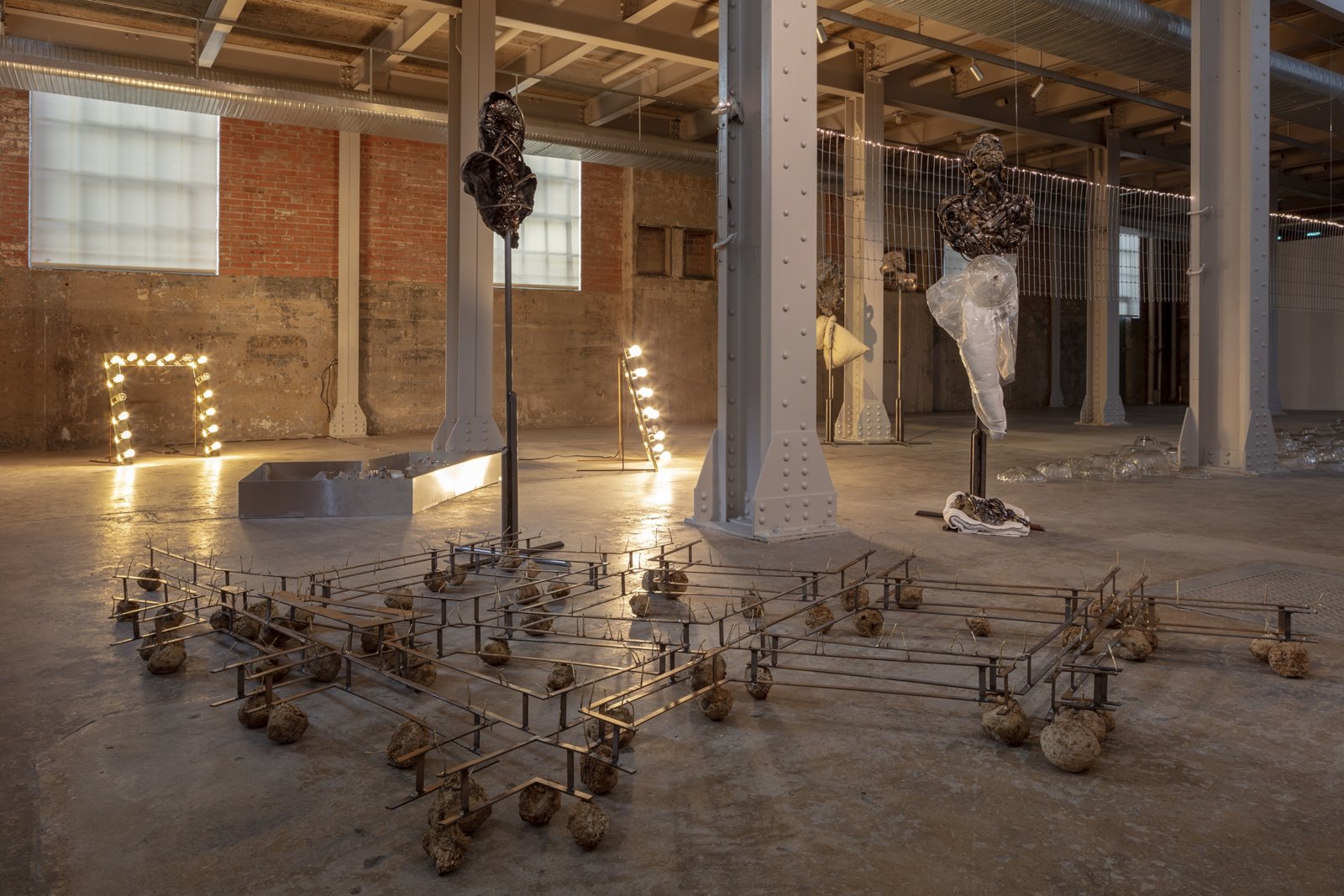 Rochelle Goldberg, Track (can you trigger the switch?), 2018, celeriac, steel, brass, dispersion paint, 8 x 139 x 71 in. (20 x 353 x 180 cm). Installation view, born in a beam of light, The Power Station, Dallas, 2019