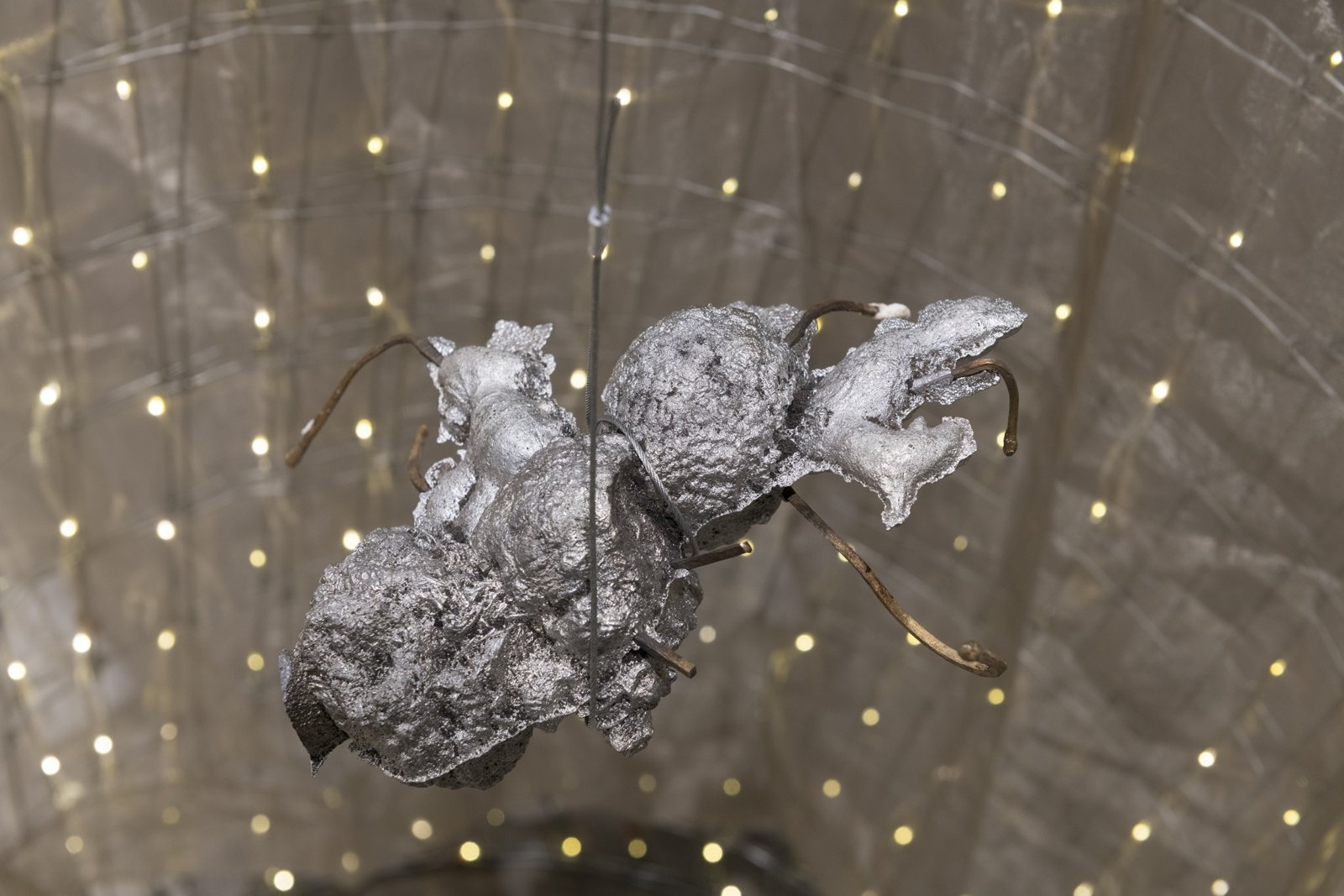 Rochelle Goldberg, Trigger: Towards everything they’ve ever wanted (detail), 2019, ranch fencing, batteries, fairy lights, polyester curtain, aluminum, cast bronze matches, copper wire, 51 x 51 x 44 in. (130 x 130 x 112 cm). Installation view, In the No Longer Not Yet, Leonard and Bina Ellen Art Gallery, Montreal, 2020