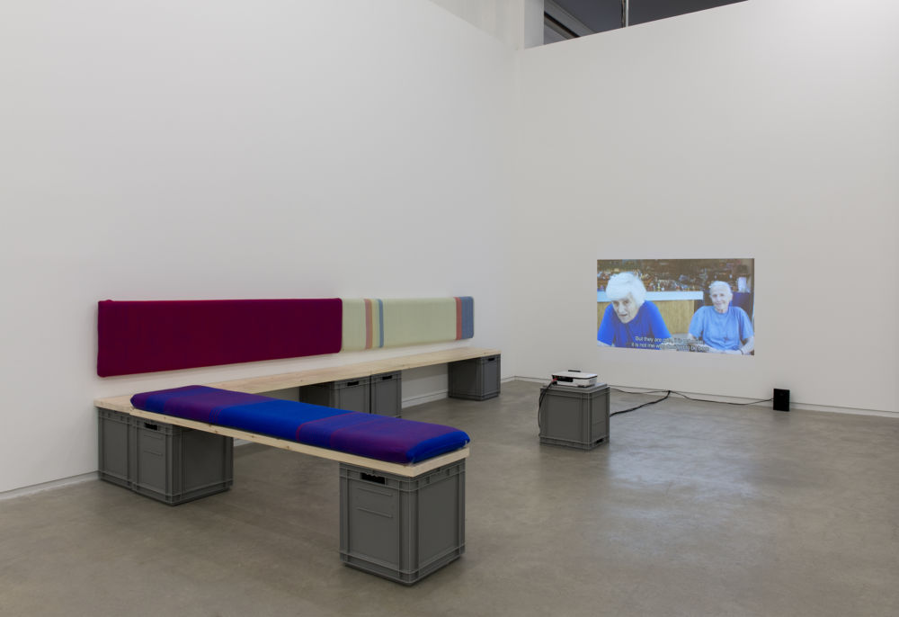 Andrea Büttner, Benches, 2013, handwoven wool backrests, spruce, plastic crates, each 37 x 78 x 16 in. (93 x 2 x 40 cm), Little sisters, Lunapark, Ostia, 2012, HDV, dimensions variable by 