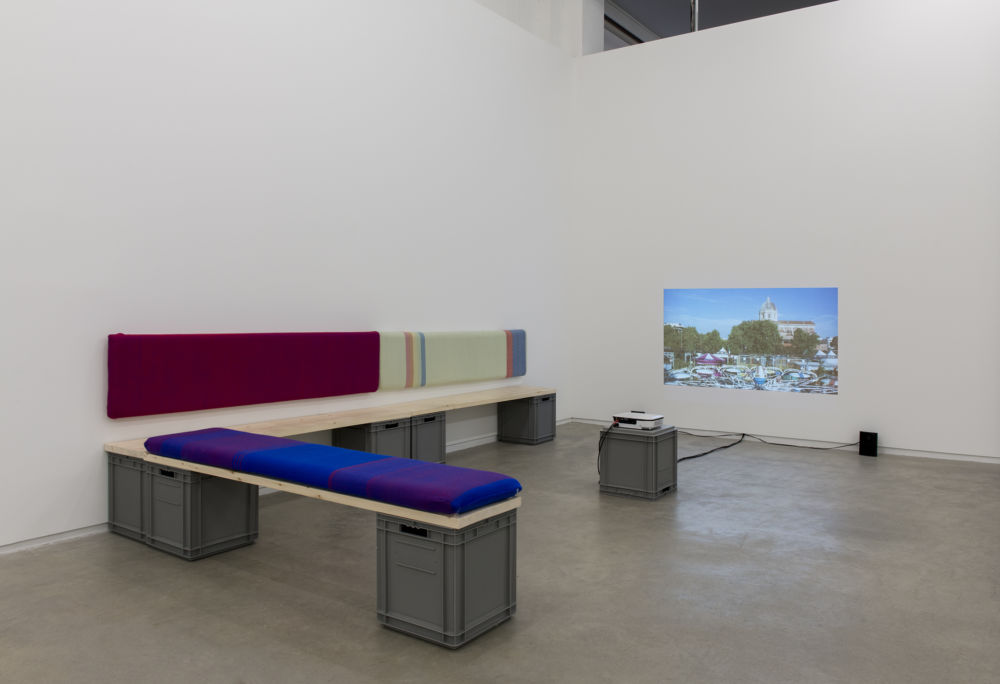 Andrea Büttner, Benches, 2013, handwoven wool backrests, spruce, plastic crates, each 37 x 78 x 16 in. (93 x 2 x 40 cm), Little sisters, Lunapark, Ostia, 2012, HDV, dimensions variable by 