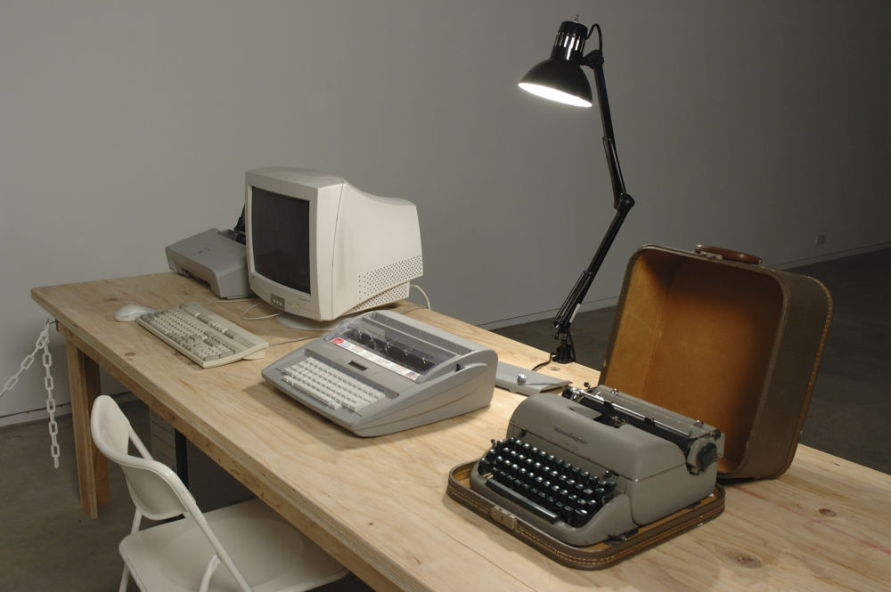 Isabelle Pauwels, Untitled, 2006, remington manual typewriter, brother sx-4000 electronic typewriter, CPU, monitor, printer, white office chair, shelf, lamp, time cards, filing tray, office supplies, galley slave edition poster, dimensions variable by 