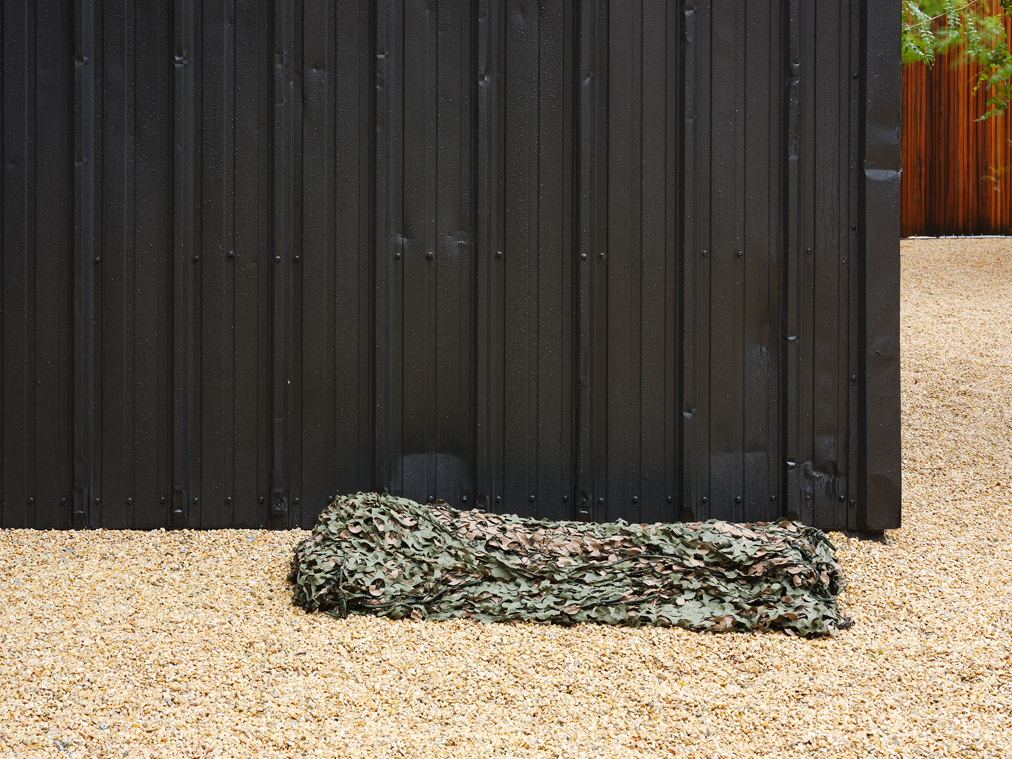 Abbas Akhavan, not titled, 2021, camouflage netting, 11 x 26 x 60 in. (28 x 65 x 152 cm) by 