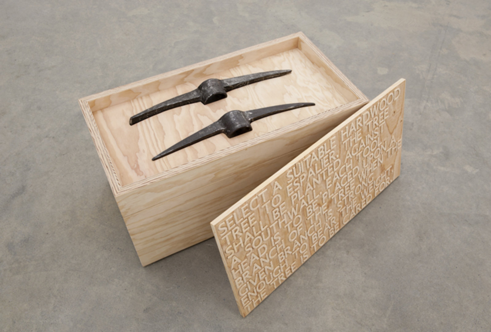 Brian Jungen, Bushido, 2012, fir plywood, axe heads, tree, book, 16 x 31 x 16 in. (41 x 79 x 41 cm)