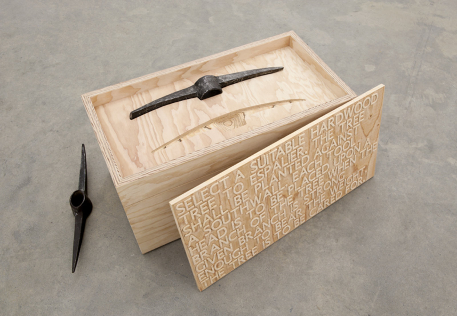 Brian Jungen, Bushido, 2012, fir plywood, axe heads, tree, book, 16 x 31 x 16 in. (41 x 79 x 41 cm)