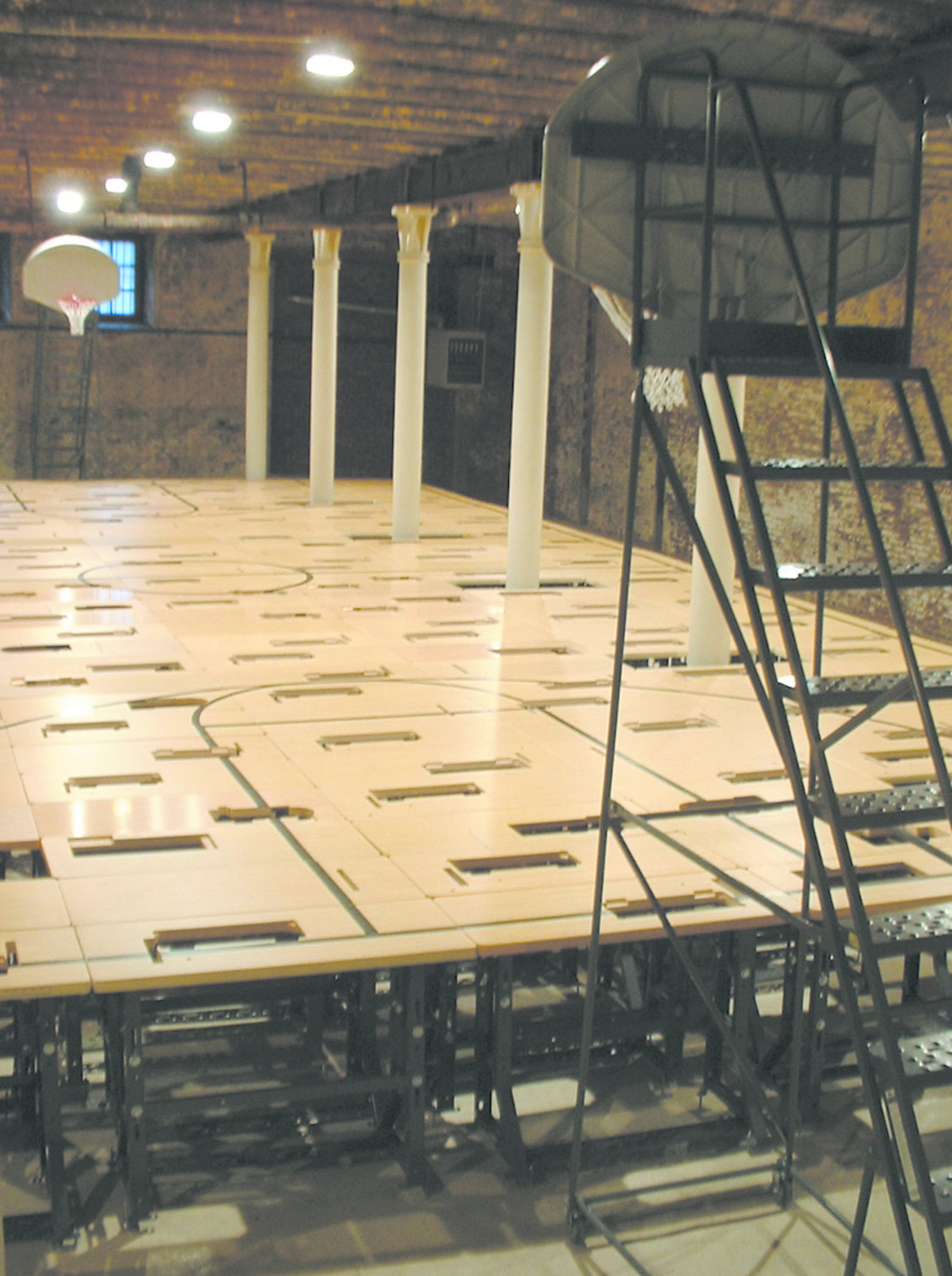 Brian Jungen, Court, 2004, 224 sweatshop tables, paint, 2 rolling steel warehouse ladders, 2 basketball hoops each with net and backboard, 148 x 336 x 840 in. (376 x 853 x 2134 cm)