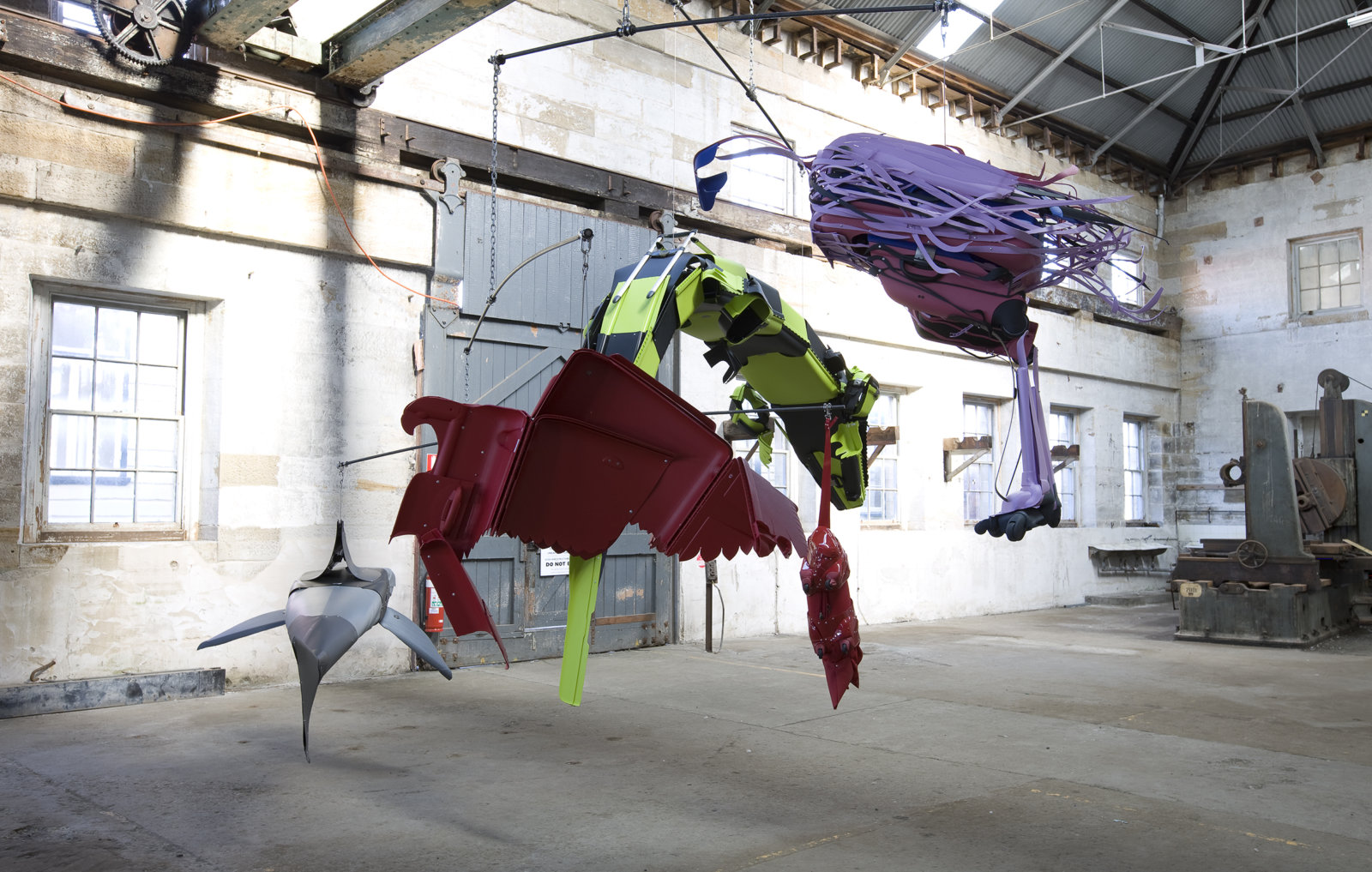 Brian Jungen, Crux (as seen from those who sleep on the surface of the earth under the night sky), 2008, suspended mobile of steel, cut up travel suitcases, rowboat with oars installed on ground, dimensions variable. Installation view, Sydney	Biennale,	Sydney,	Australia, 2008