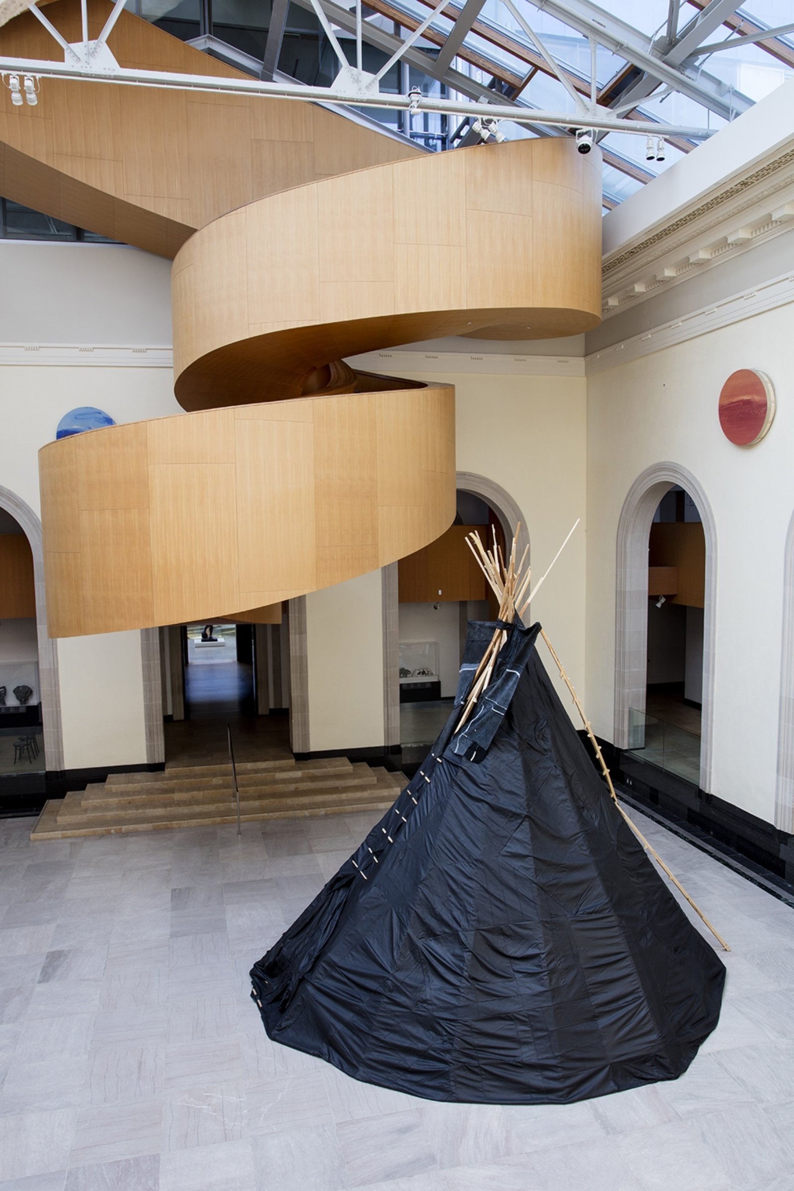 Brian Jungen, Furniture Sculpture, 2006, 11 black leather couches, wood, 244 x 232 x 284 in. (620 x 589 x 721 cm). Installation view, Art Gallery of Ontario, Toronto, Canada, 2019