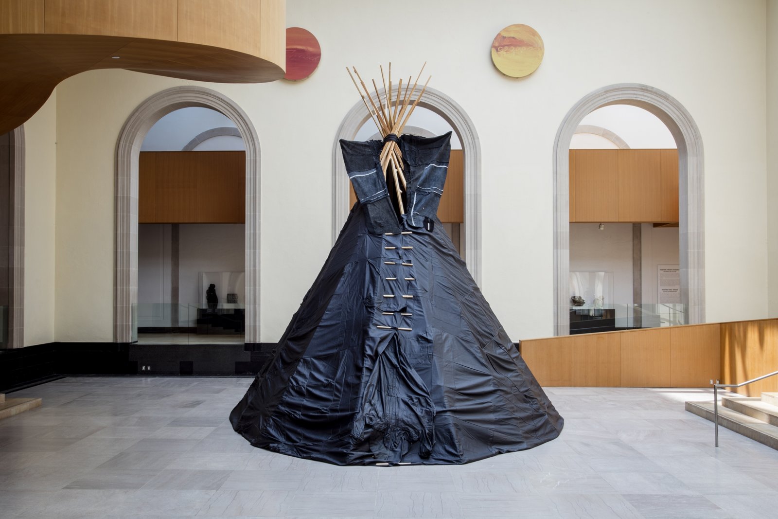 Brian Jungen, Furniture Sculpture, 2006, 11 black leather couches, wood, 244 x 232 x 284 in. (620 x 589 x 721 cm). Installation view, Art Gallery of Ontario, Toronto, Canada, 2019