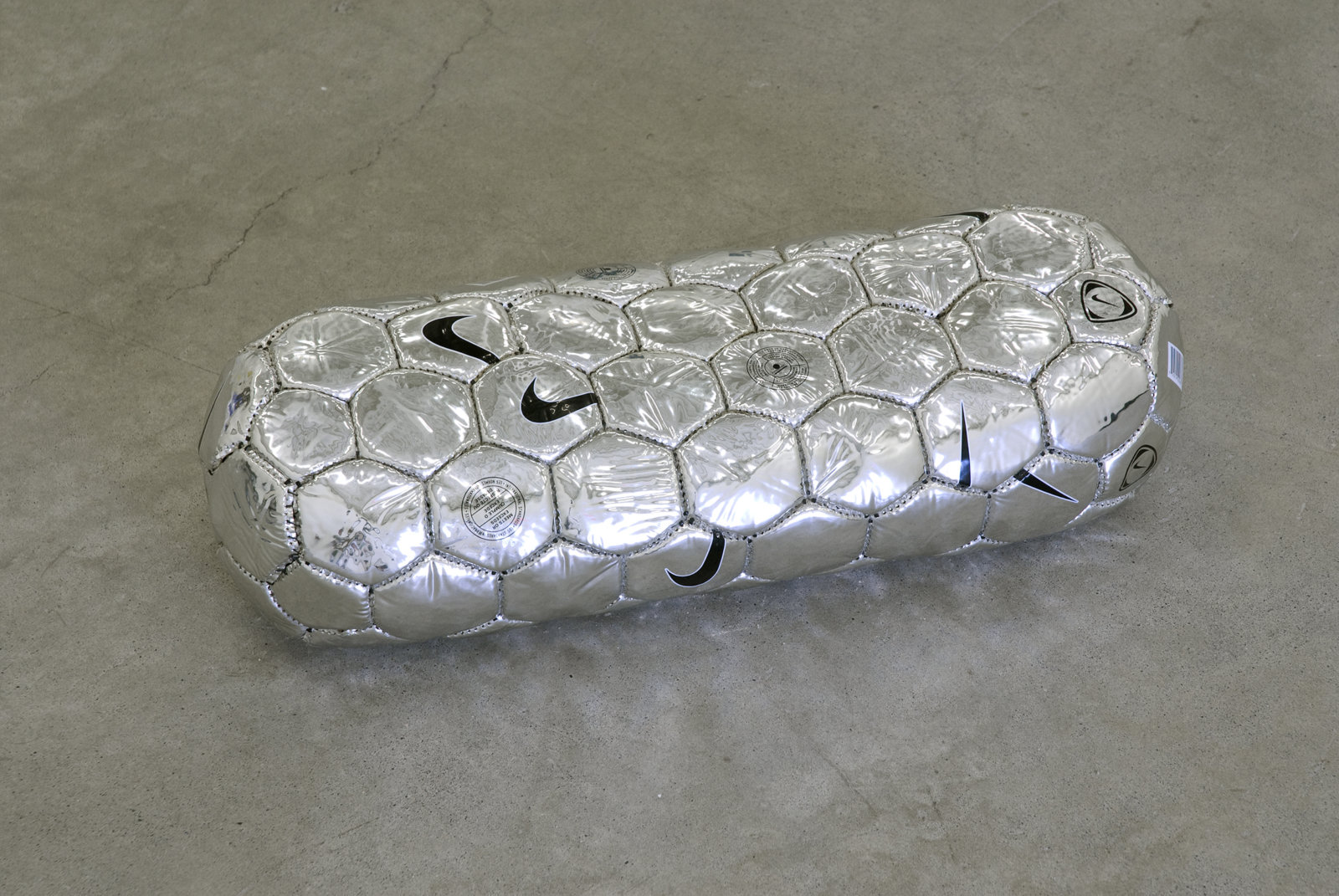 Brian Jungen, Modern Sculpture (After Iceland) (detail), 2005, 6 sculptural forms of lava rock and soccer balls, dimensions variable