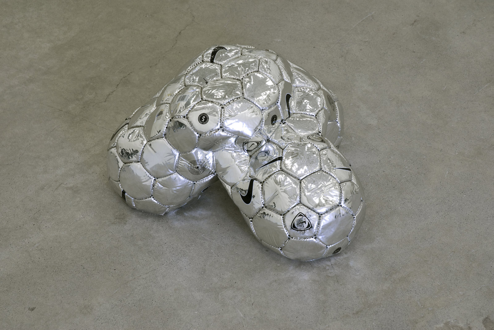 Brian Jungen, Modern Sculpture (After Iceland) (detail), 2005, 6 sculptural forms of lava rock and soccer balls, dimensions variable