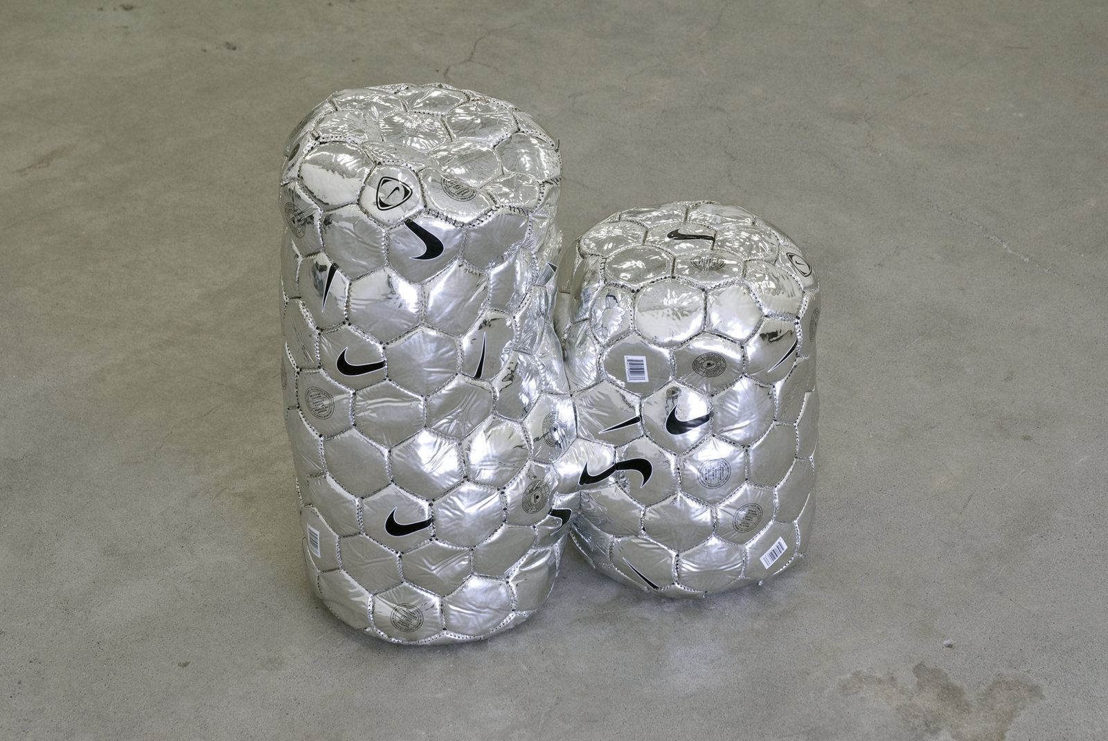 Brian Jungen, Modern Sculpture (After Iceland) (detail), 2005, 6 sculptural forms of lava rock and soccer balls, dimensions variable