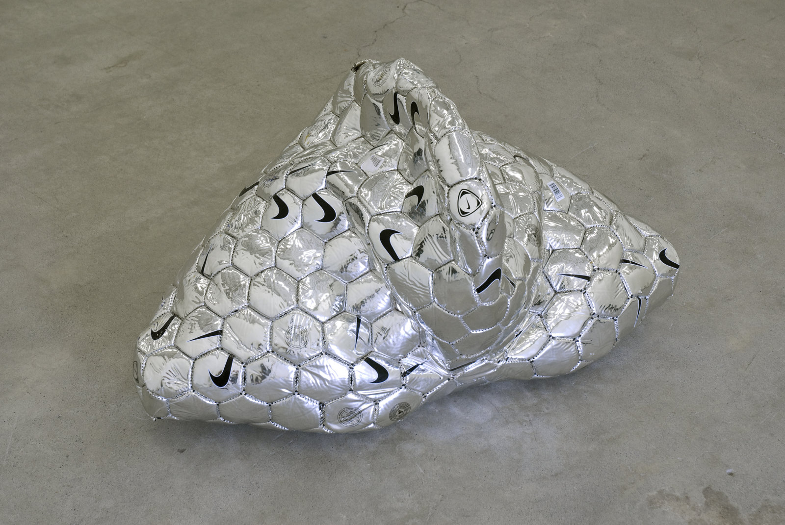 Brian Jungen, Modern Sculpture (After Iceland) (detail), 2005, 6 sculptural forms of lava rock and soccer balls, dimensions variable