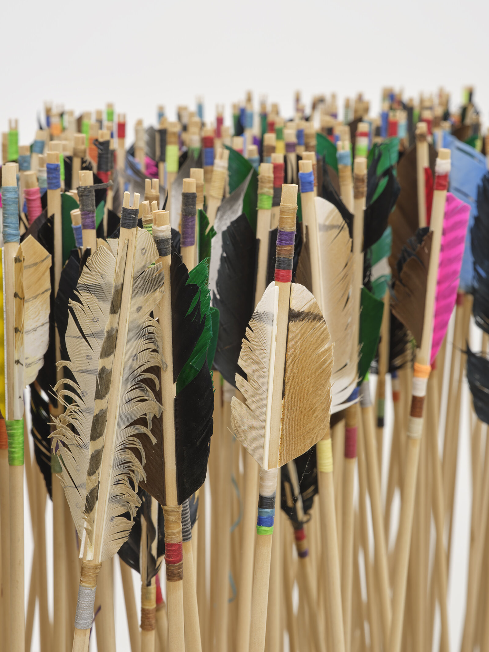 Brian Jungen, The Way of the World (detail), 2024, 250-year-old French colonial oak table from Baton Rouge, wood arrows, carbon steel points, feather, artificial sinew, 63 x 76 x 29 in. (160 x 193 x 74 cm)