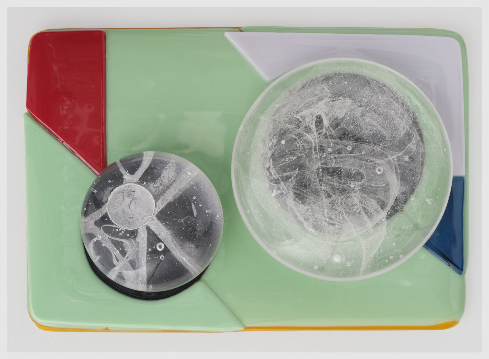 Devon Knowles, Is, Was, Here, 2022, glass, 3 parts, yellow 3 x 10 x 7 in. (6 x 25 x 18 cm); blue 3 x 10 x 7 in. (6 x 25 x 17 cm); mint 2 x 10 x 7 in. (5 x 25 x 18 cm)