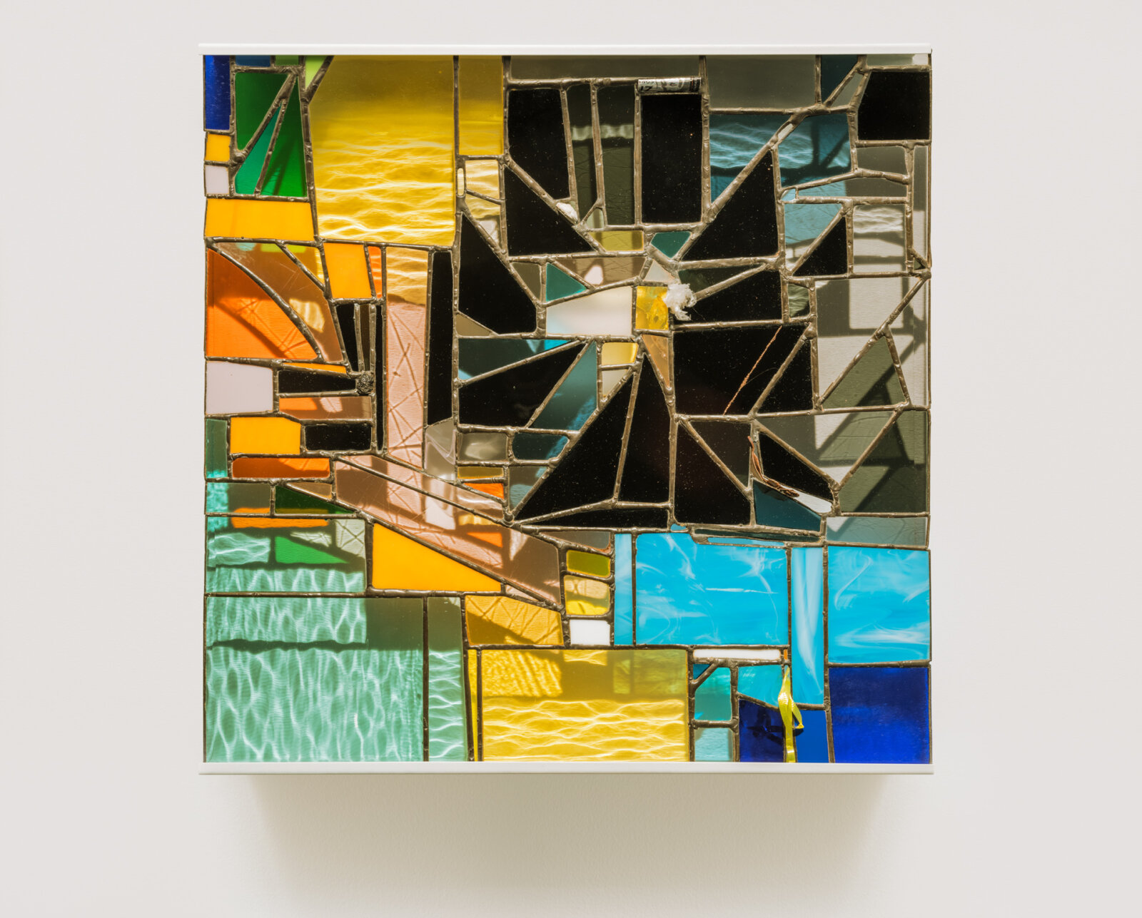 Devon Knowles, Walking Spectrum I S17, 2018, glass, plastic bag, plastic packaging, plastic ribbon, rolling paper packaging, CAD currency, lead, tin, asphalt, styrofoam, leaves, copper, steel, paint, 20 x 20 x 2 in. (51 x 51 x 5 cm)