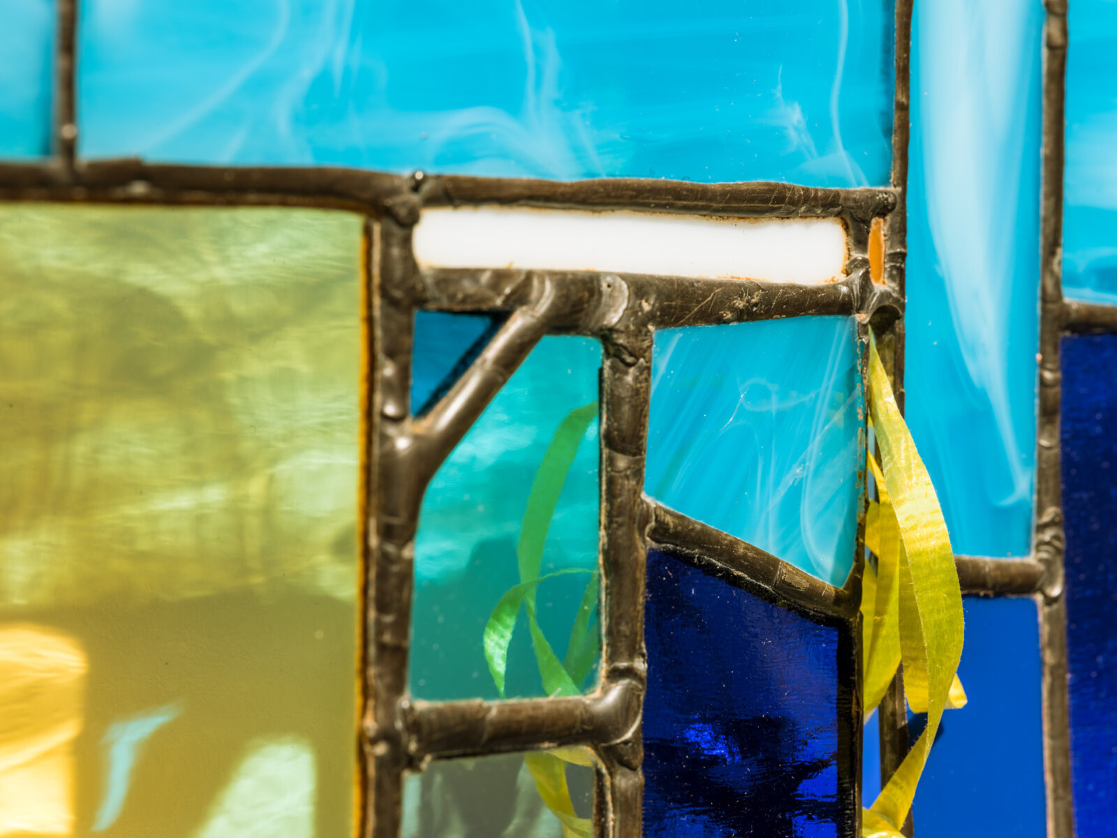 Devon Knowles, Walking Spectrum I S17 (detail), 2018, glass, plastic bag, plastic packaging, plastic ribbon, rolling paper packaging, CAD currency, lead, tin, asphalt, styrofoam, leaves, copper, steel, paint, 20 x 20 x 2 in. (51 x 51 x 5 cm)