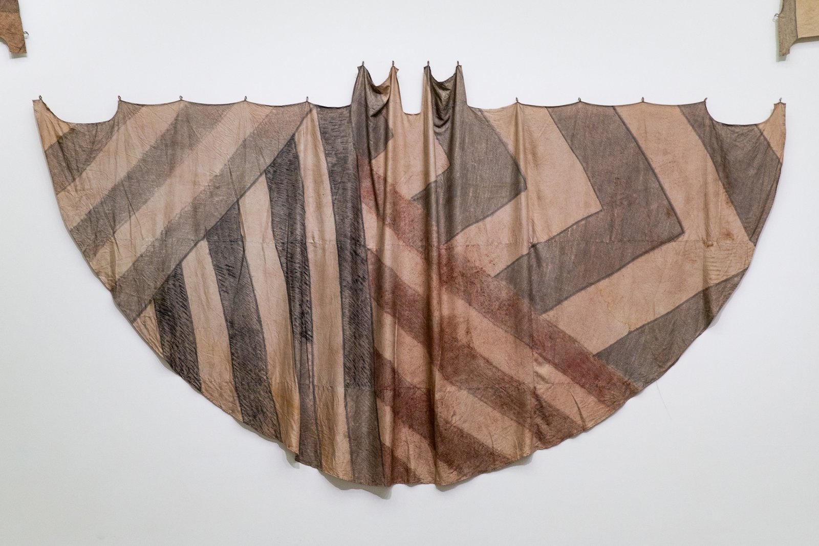 Duane Linklater, Tipi cover for deep forest dazzle / four on the floor for Tobias, 2018, digital print on hand-dyed linen, sumac, cedar, charcoal, nails, 117 x 230 in. (296 x 584 cm). Installation view, Post-Nature—A Museum as an Ecosystem, Taipei Biennial 2018, Taipei Fine Arts Museum, Taiwan, 2018