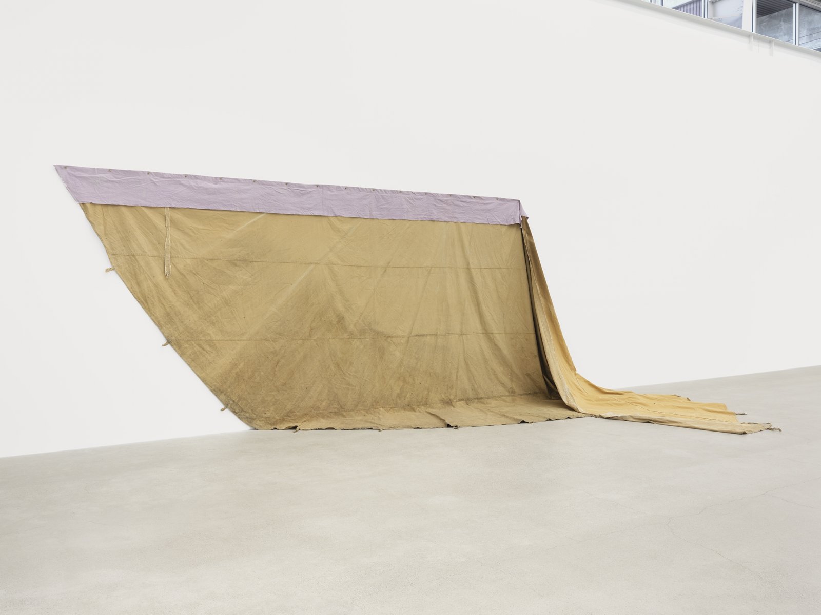 Duane Linklater, a gift from Doreen, 2016–2019, hand-dyed canvas, teepee canvas, blueberry extract, grommets, nails, 108 x 270 x 123 in. (274 x 686 x 312 cm)