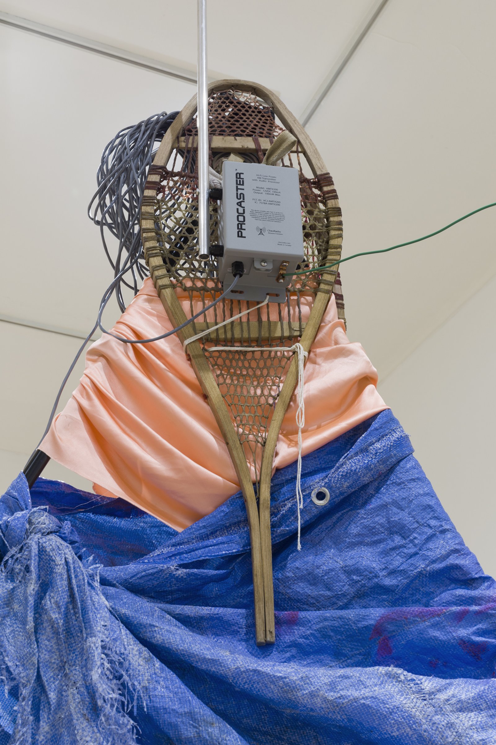 Duane Linklater, apparatus for the dissemination of Indigenous ideas and sounds into the air (detail), 2017, tripod, radio transmitter, hand-dyed snowshoes, tarpaulin, fabric, string, stone, tape, speaker, paint, wiring, dimensions variable. Installation view, apparatus for the circulation of Indigenous ideas and sounds into the air, Western Front, Vancouver, 2017