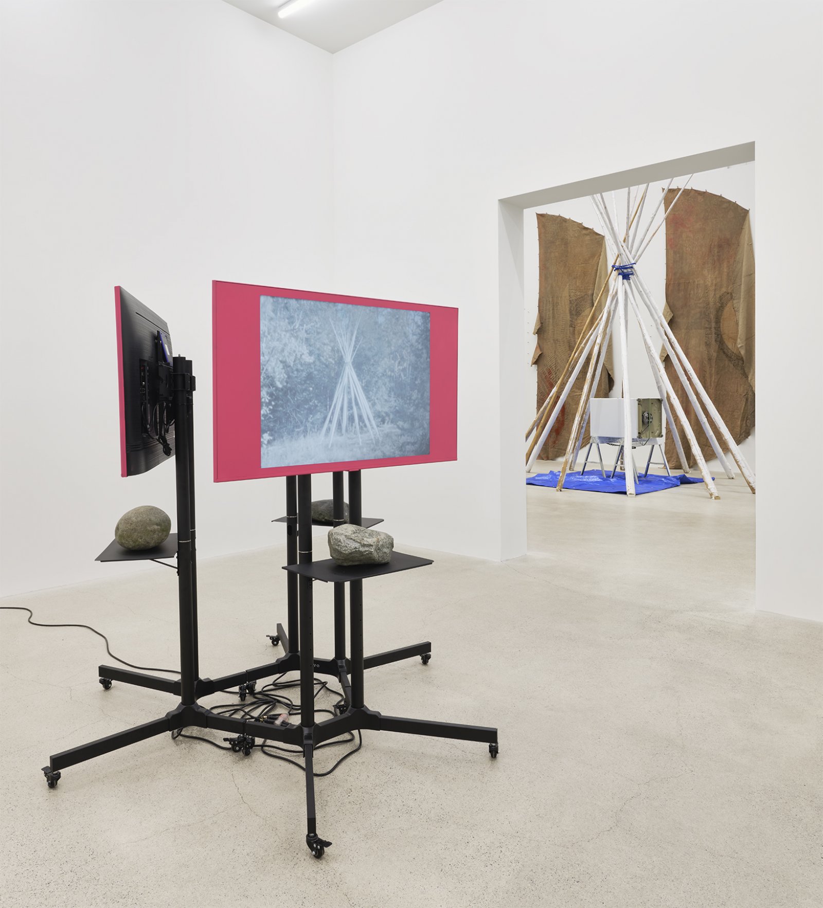 Duane Linklater, primaryuse, 2020, lcd screens, television stands, media players, spray paint, stones, 3 super 8mm film transfers to 2k video with audio, score by eagles with eyes closed, looping: 5 minutes, 19 seconds; 5 minutes, 10 seconds; 5 minutes, 23 seconds; 69 x 72 x 72 in. (175 x 183 x 183 cm)