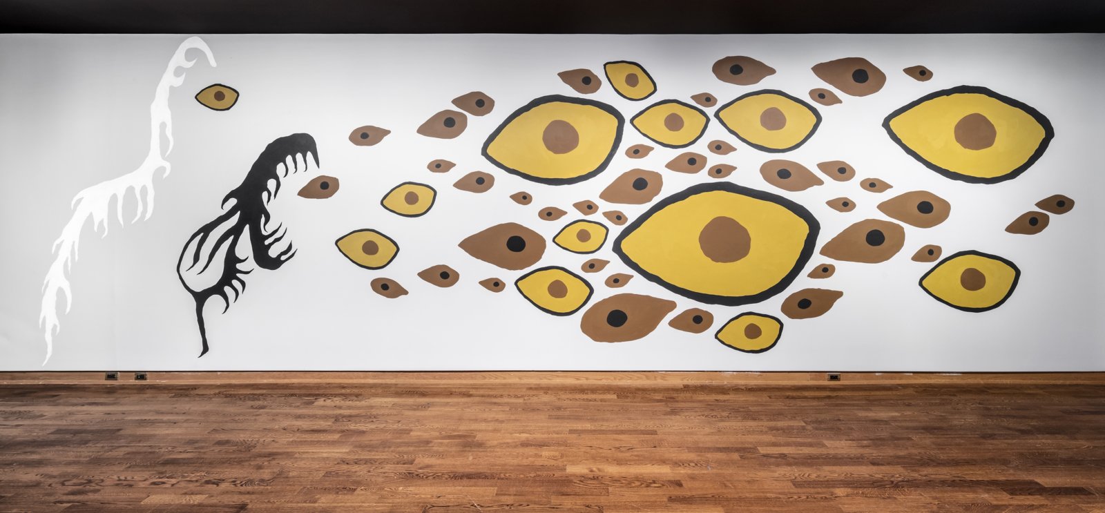 Duane Linklater, Earth Mother Hair, Indian Hair, and Earth Mother Eyes, Indian Eyes, Animal Eyes, 2017, paint on interior wall of the Art Museum at the University of Toronto, from a series of small paintings of eyes and hair based on a photo of Norval Morrisseau’s Earth Mother and Her Children (1967), painting labour by John Abrams, absence of the artist, dimensions variable. Installation view, In Dialogue, Art Museum, Toronto, Canada, 2017