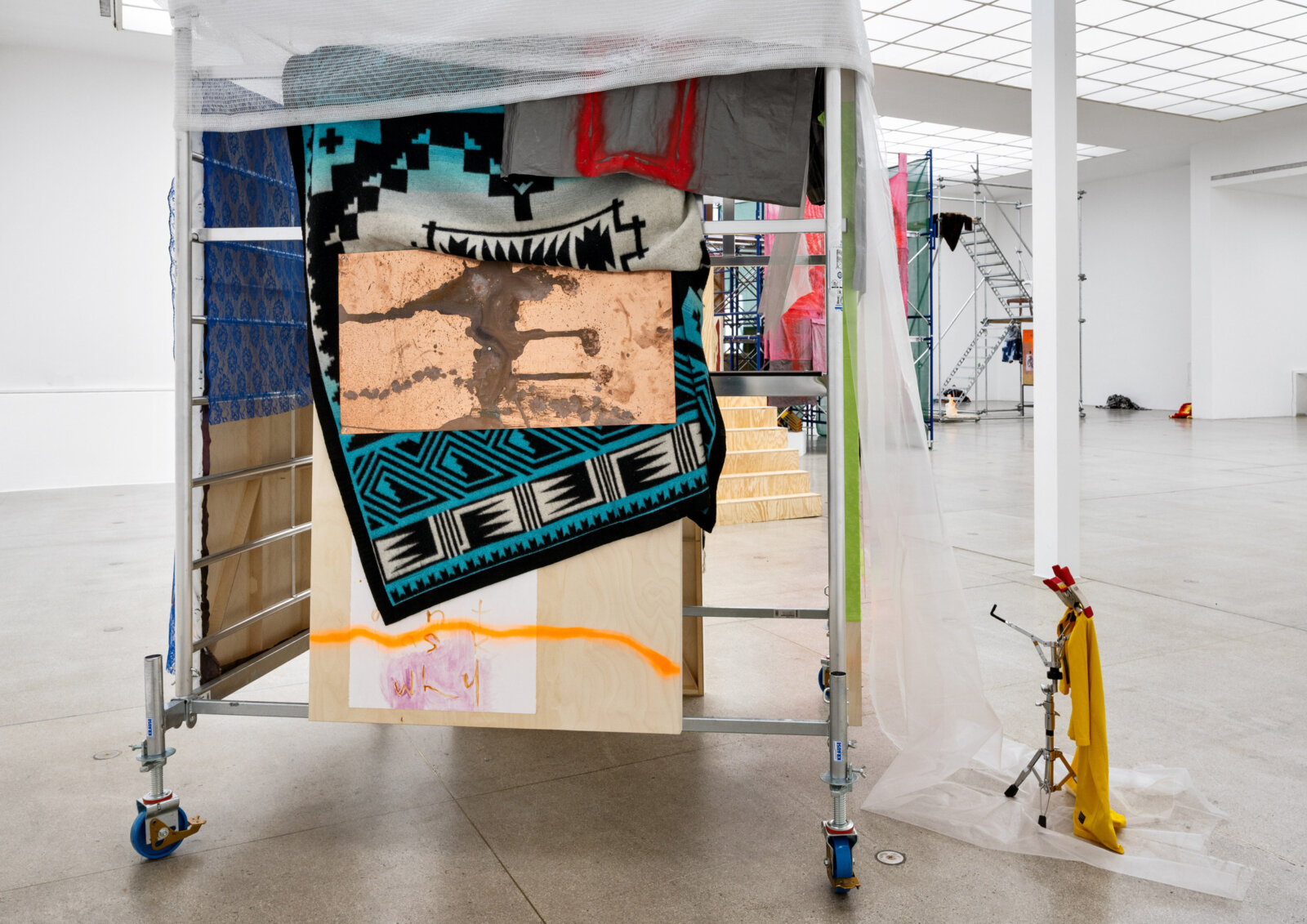 Duane Linklater, never-eat-shredded-wheat (detail), 2025, steel structure, wood panels with polyester fabric, gesso, rabbit skin glue, copper plate, wool blanket, spray paint, oil painting, sculpture, hat, wood, 158 x 138 x 79 in. (400 x 350 x 200 cm)