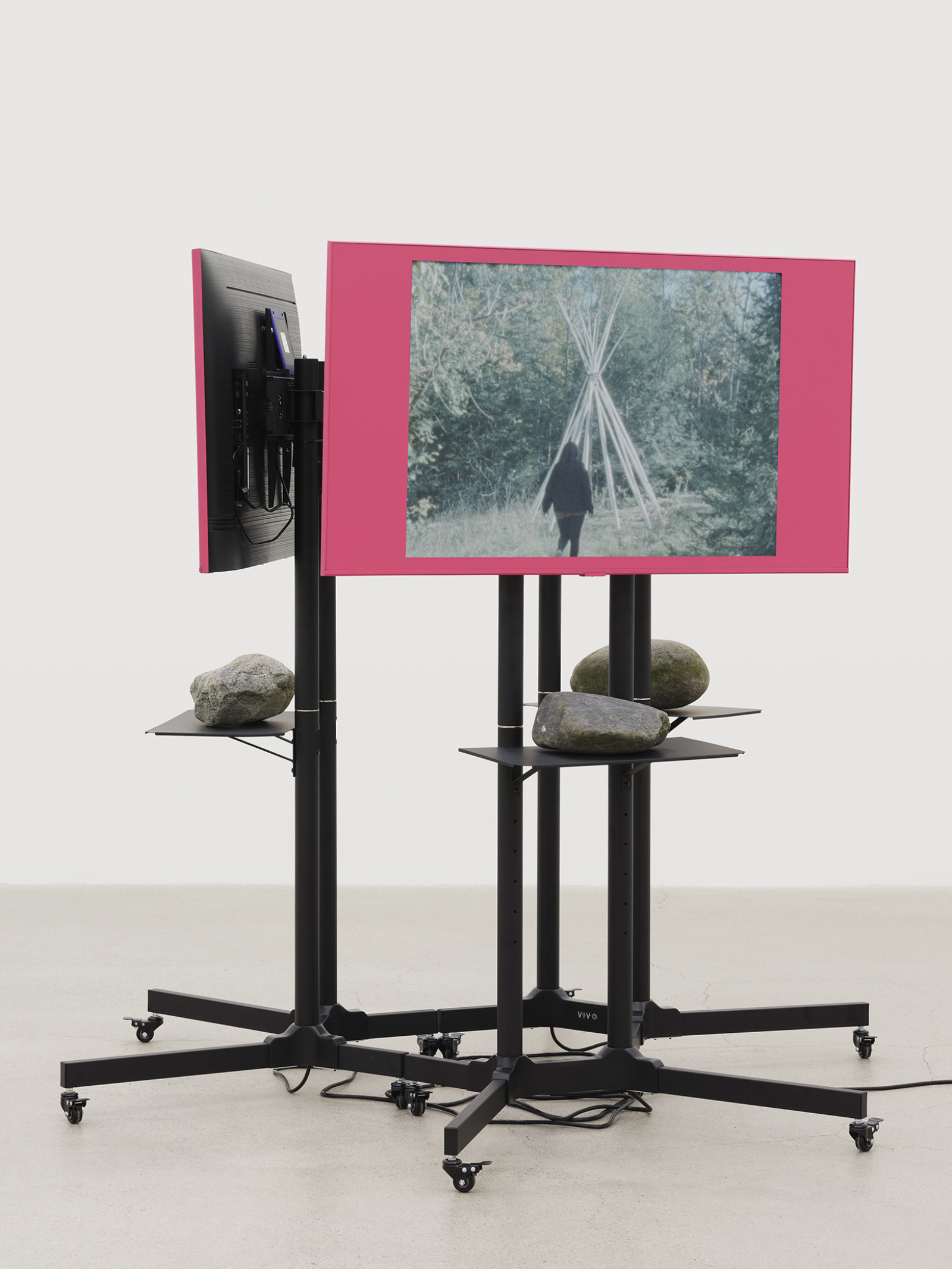 Duane Linklater, primaryuse, 2020, lcd screens, television stands, media players, spray paint, stones, 3 super 8mm film transfers to 2k video with audio, score by eagles with eyes closed, looping: 5 minutes, 19 seconds; 5 minutes, 10 seconds; 5 minutes, 23 seconds; 69 x 72 x 72 in. (175 x 183 x 183 cm)