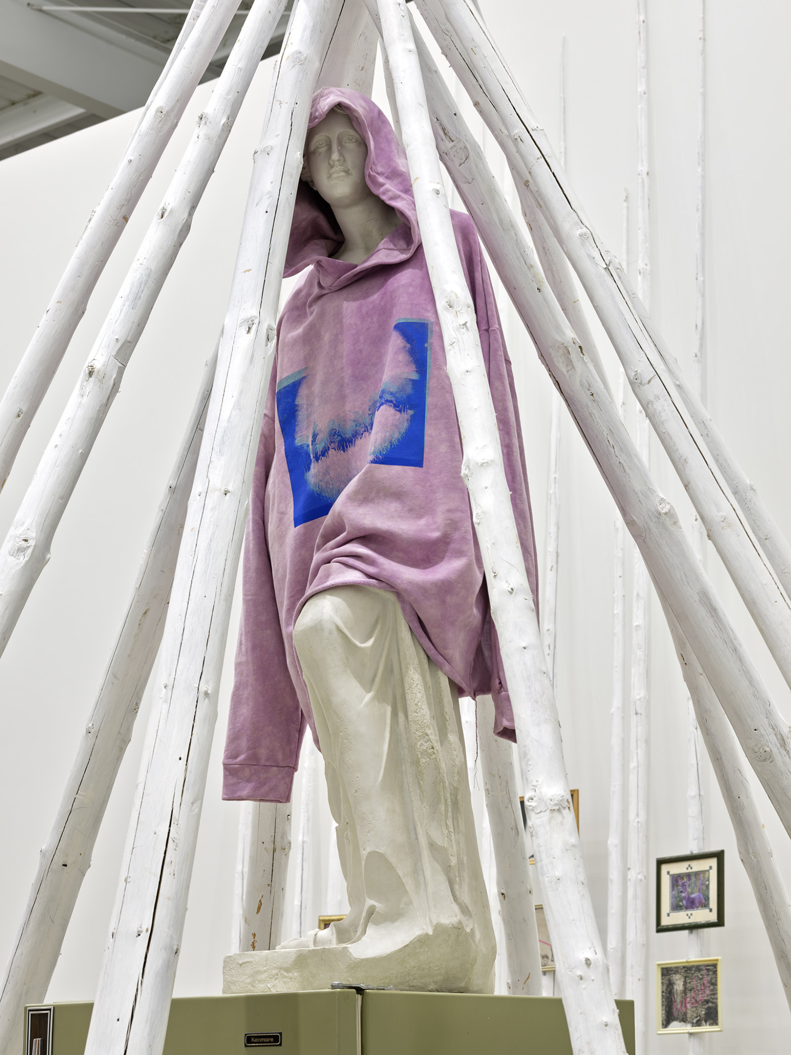 Duane Linklater, what grief conjures (detail), 2020, tipi poles, paint, nylon rope, wooden pallet, refrigerator, tie-down straps, hand truck, plastic statue, handmade hoodie, cochineal dye, silkscreen, 249 x 160 x 160 in. (632 x 406 x 406 cm)