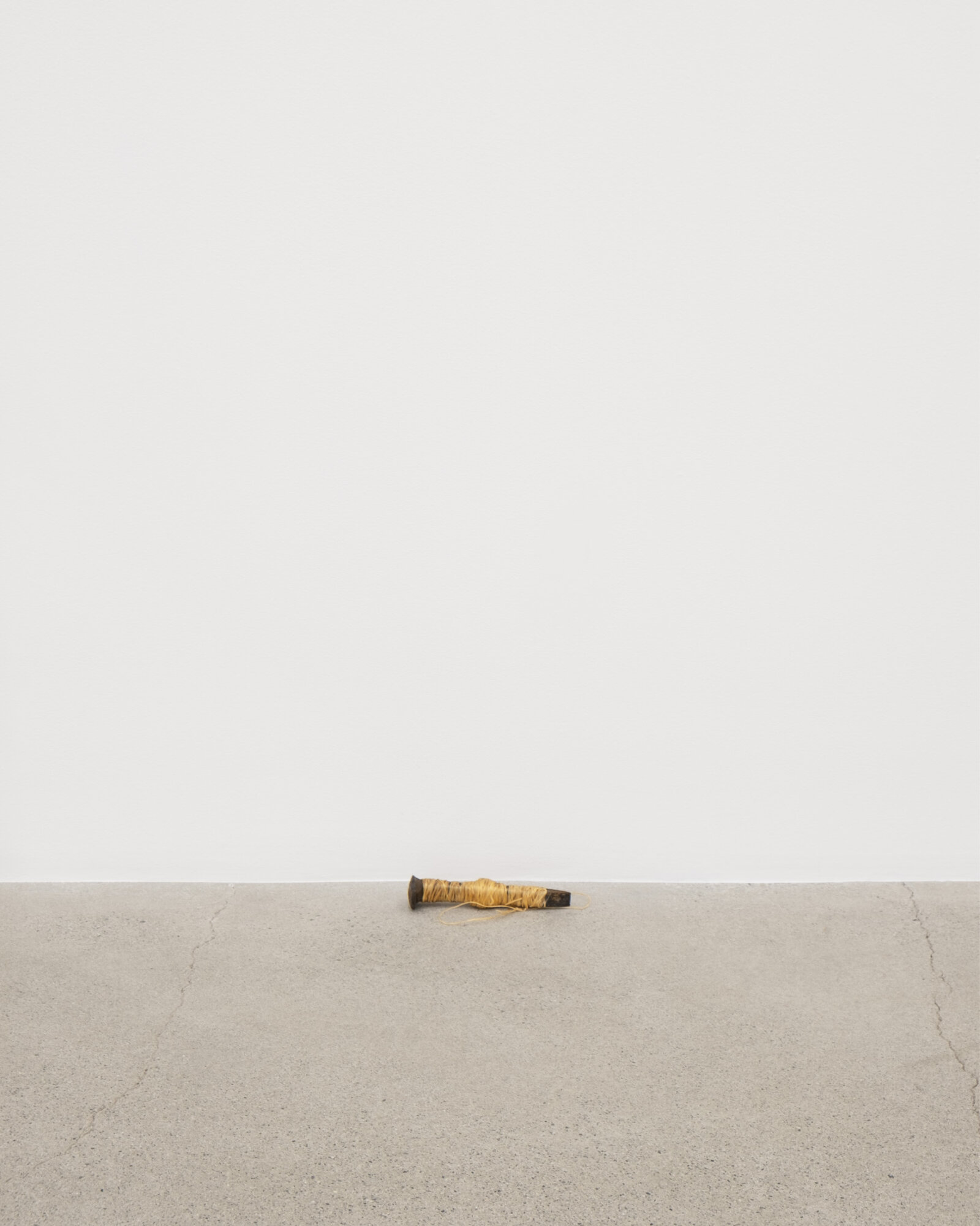 Duane Linklater, woundedknee, 2023, rail spike, sinew, 7 x 2 x 2 in. (17 x 4 x 5 cm)