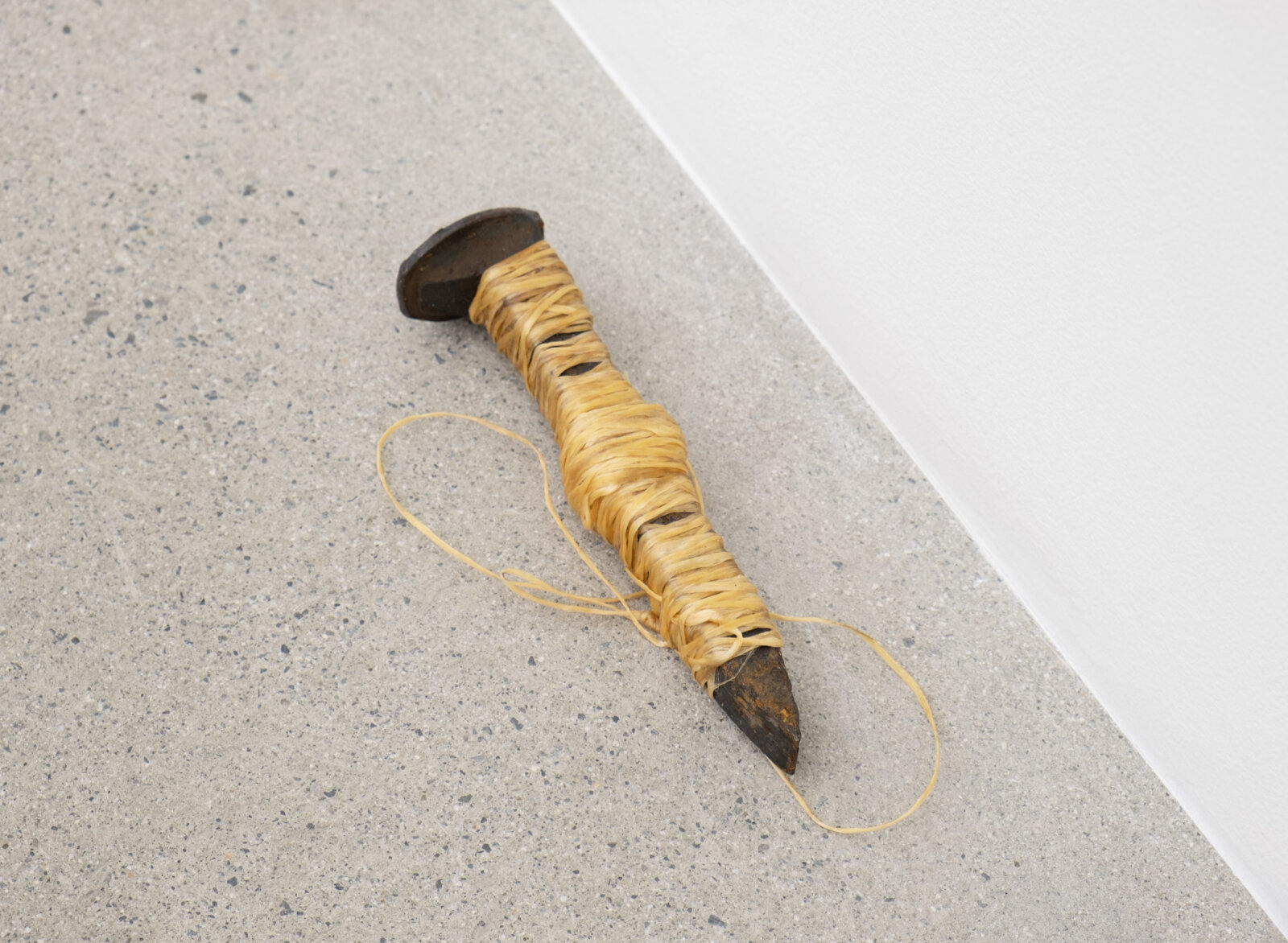 Duane Linklater, woundedknee, 2023, rail spike, sinew, 7 x 2 x 2 in. (17 x 4 x 5 cm)